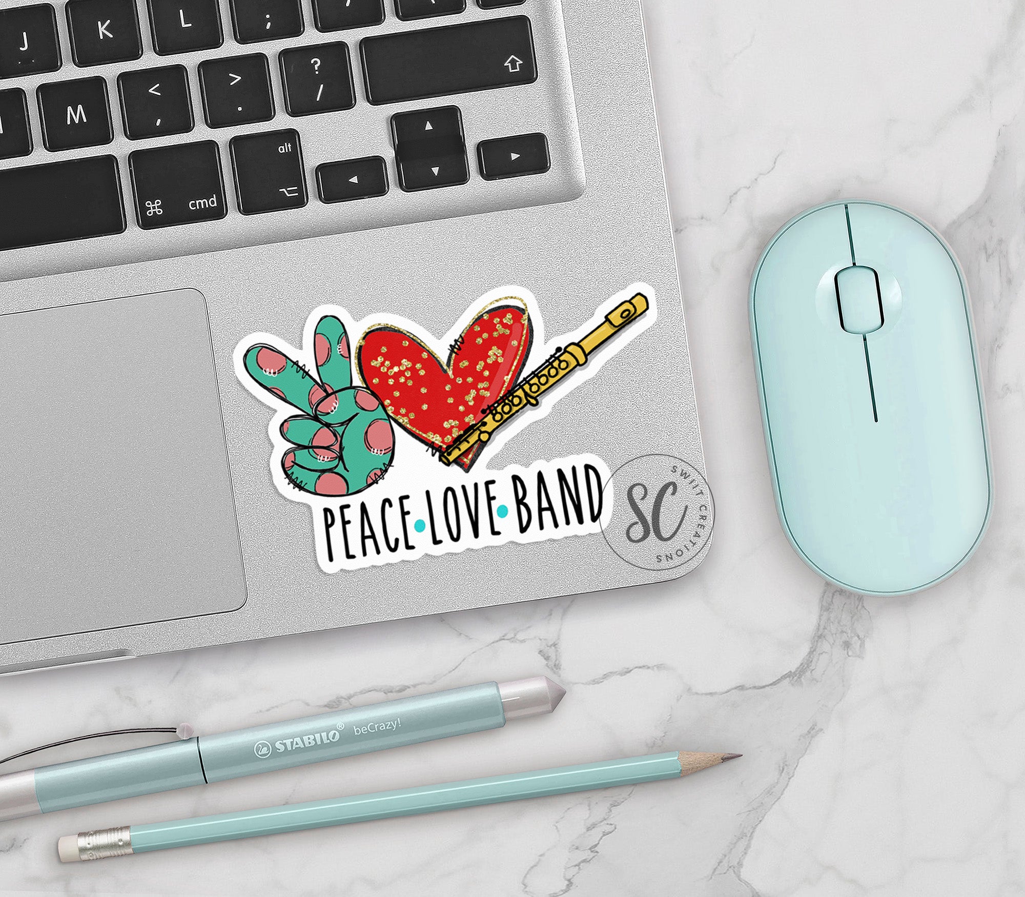 a laptop with a sticker of a peace love band on it