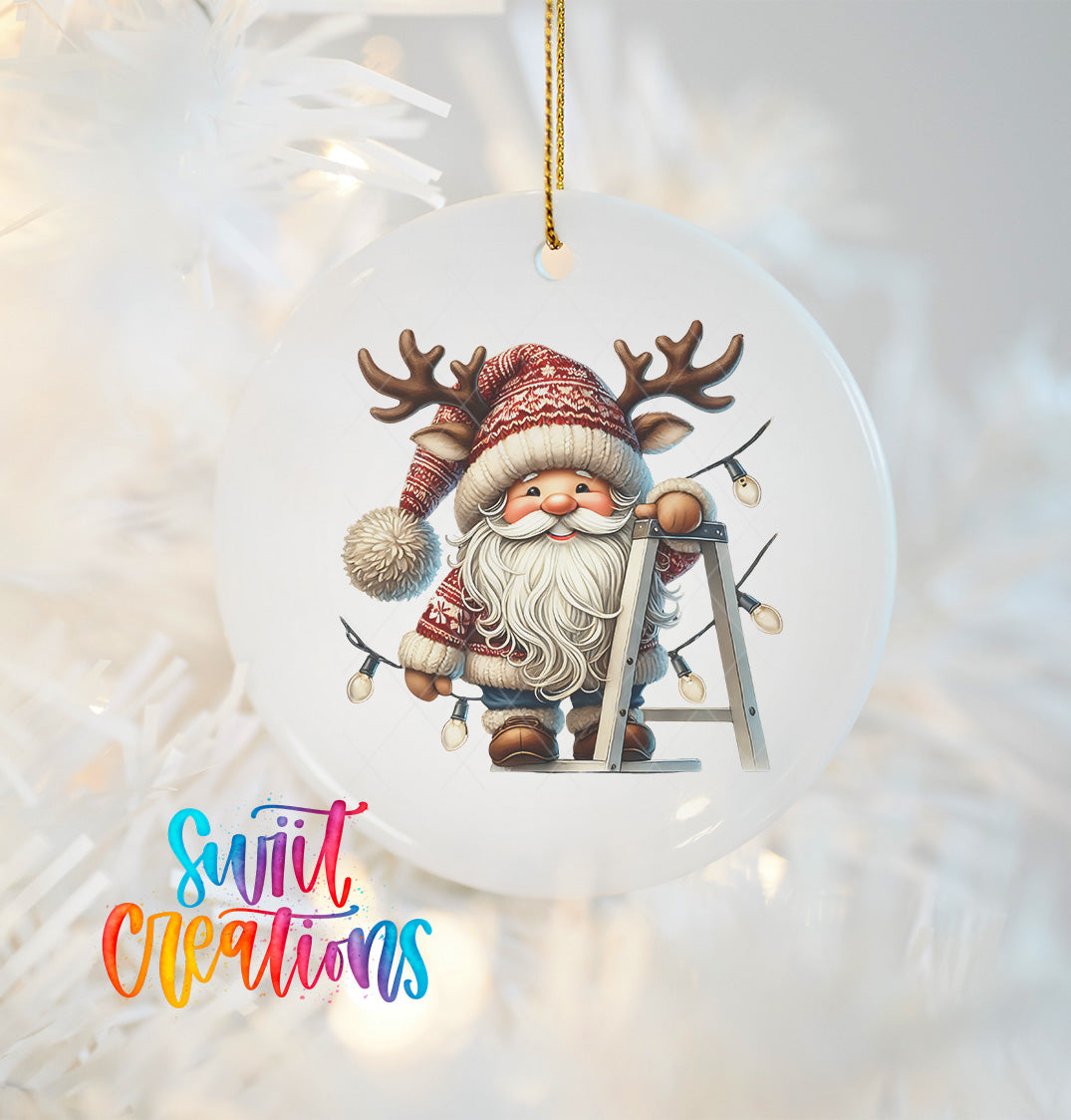 A white ornament featuring a smiling Santa Claus with antlers, wearing a red and white sweater, and holding a ladder.