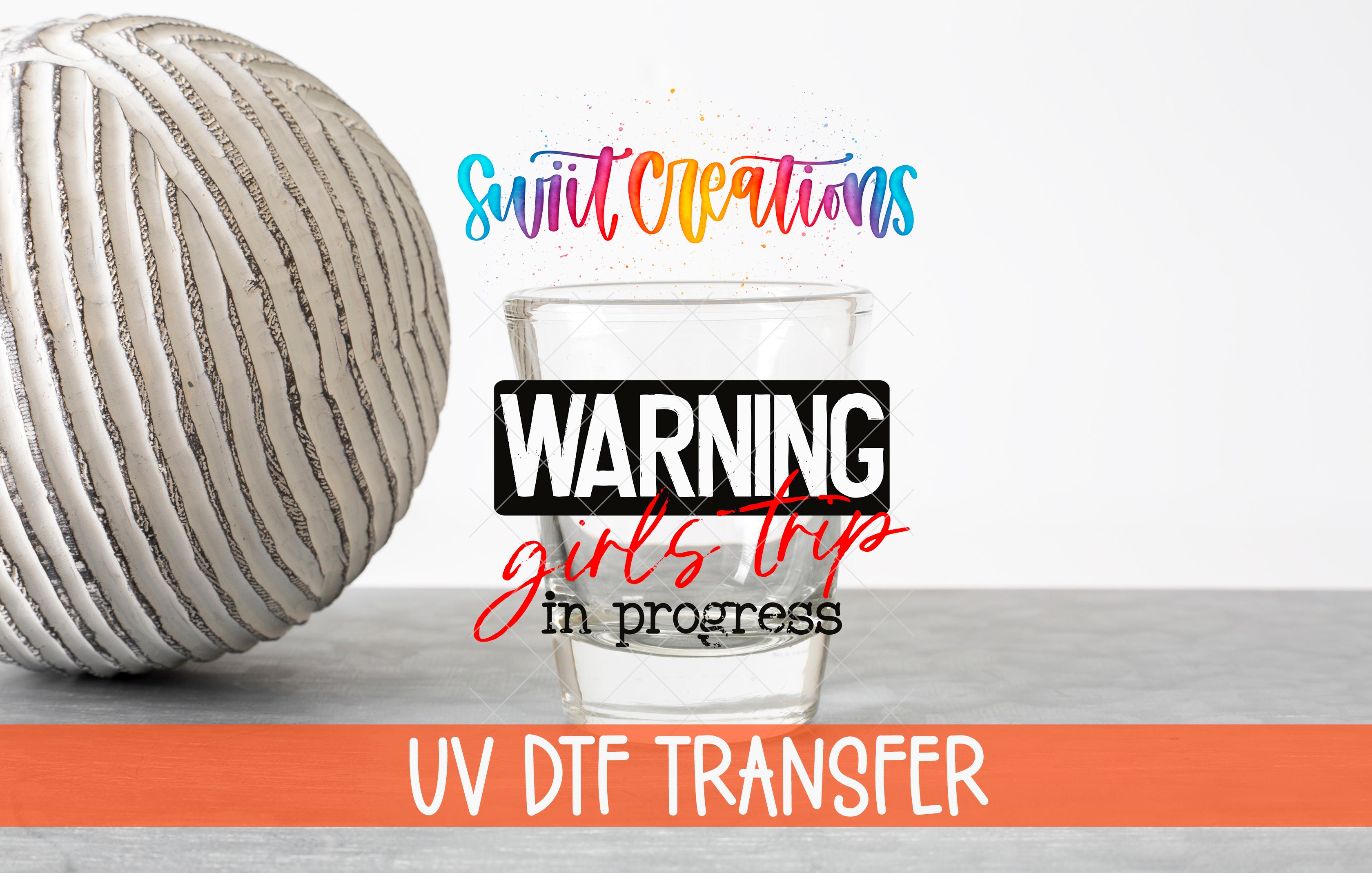 a glass of water with a ball of yarn next to it, along with text that reads "WARNING girls trip in progress UV DFT Transfer".