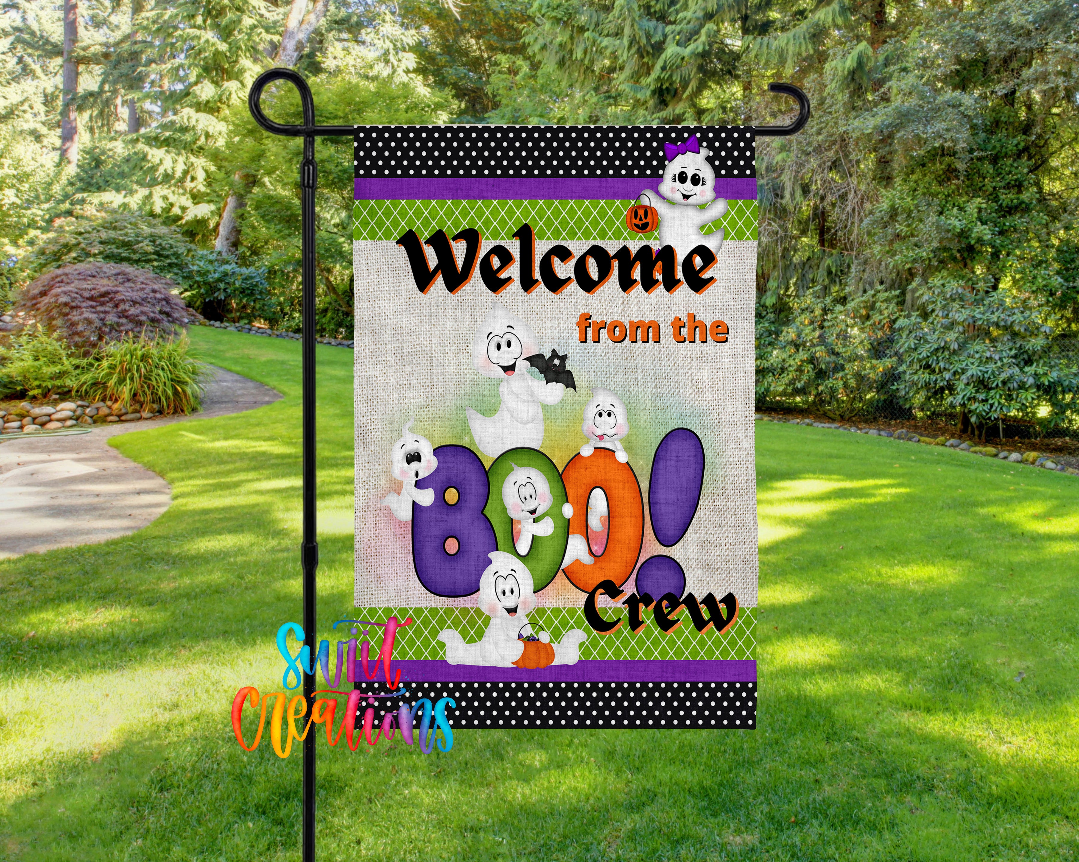A Halloween-themed welcome sign featuring cartoon ghost characters and the text "Welcome from the Boo Crew" is displayed in a garden setting.
