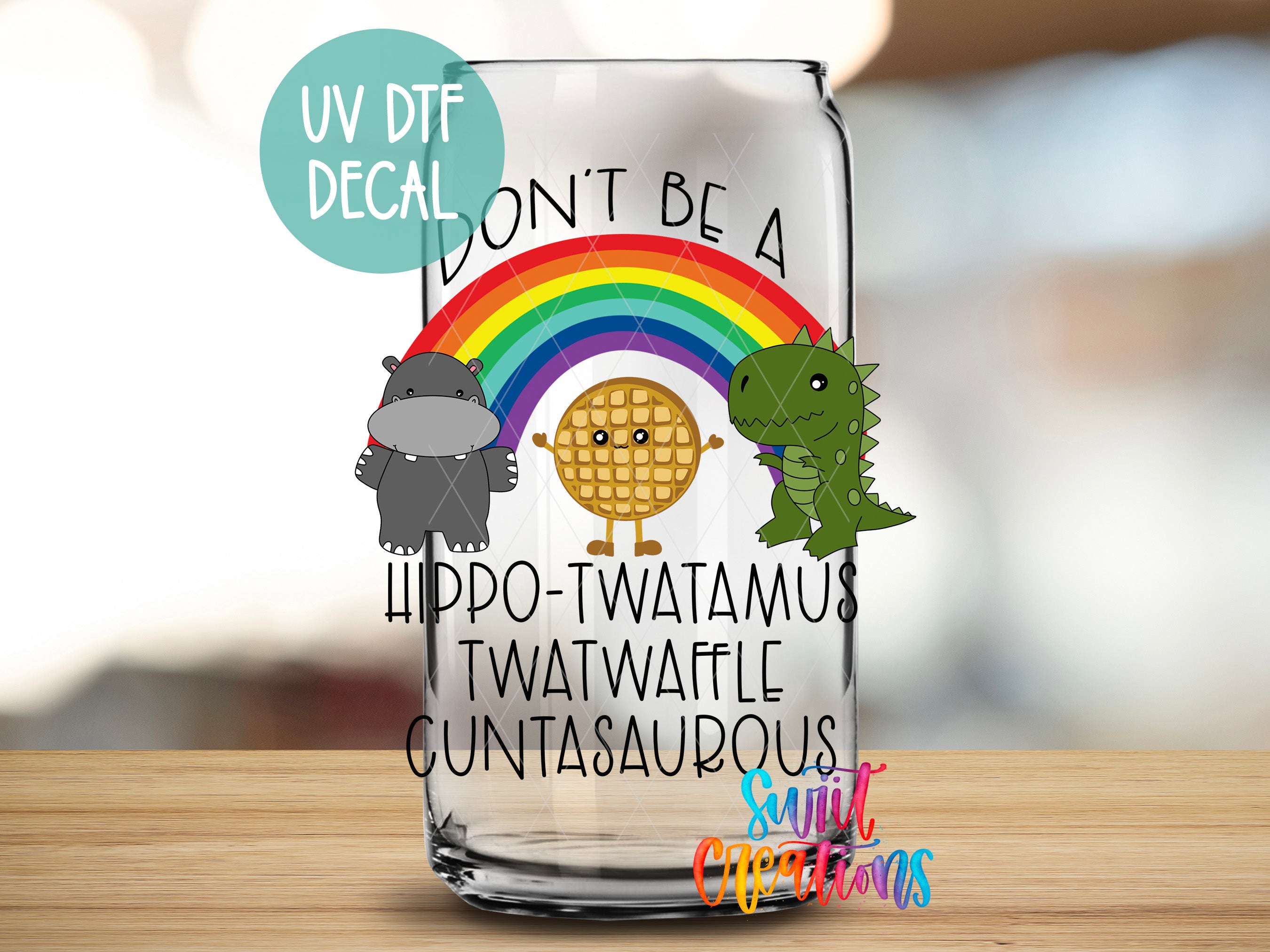 A glass jar with a cartoon illustration of a hippopotamus, a dinosaur, and a rainbow, along with the text "Don't Be A Hippo-Twatamus Twatwaffle Cuntasaurus" and a rainbow.
