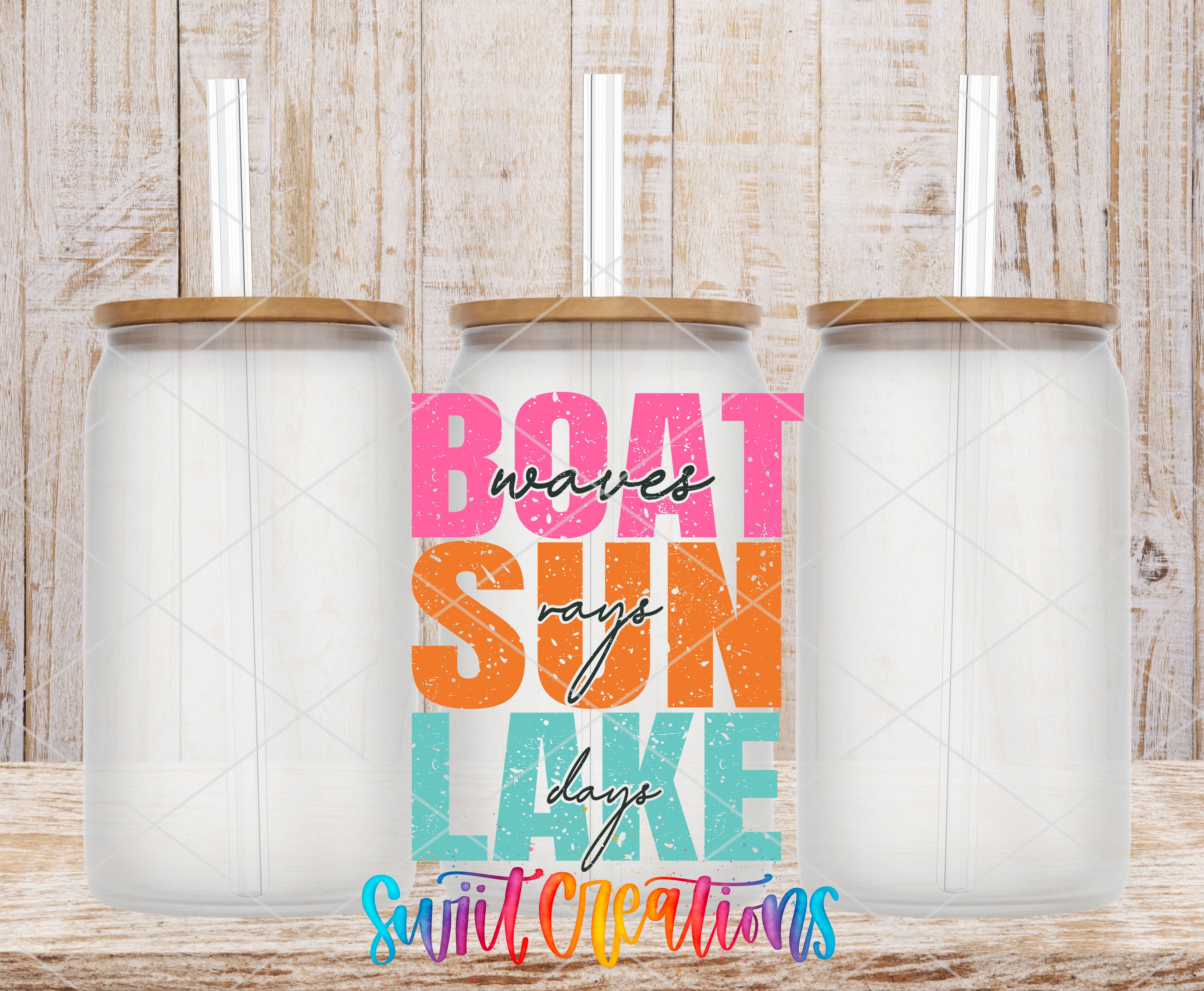 Swiit Creations UV DTF Boat Wave Sun Rays Lake Days transfer shown on a clear glass can set