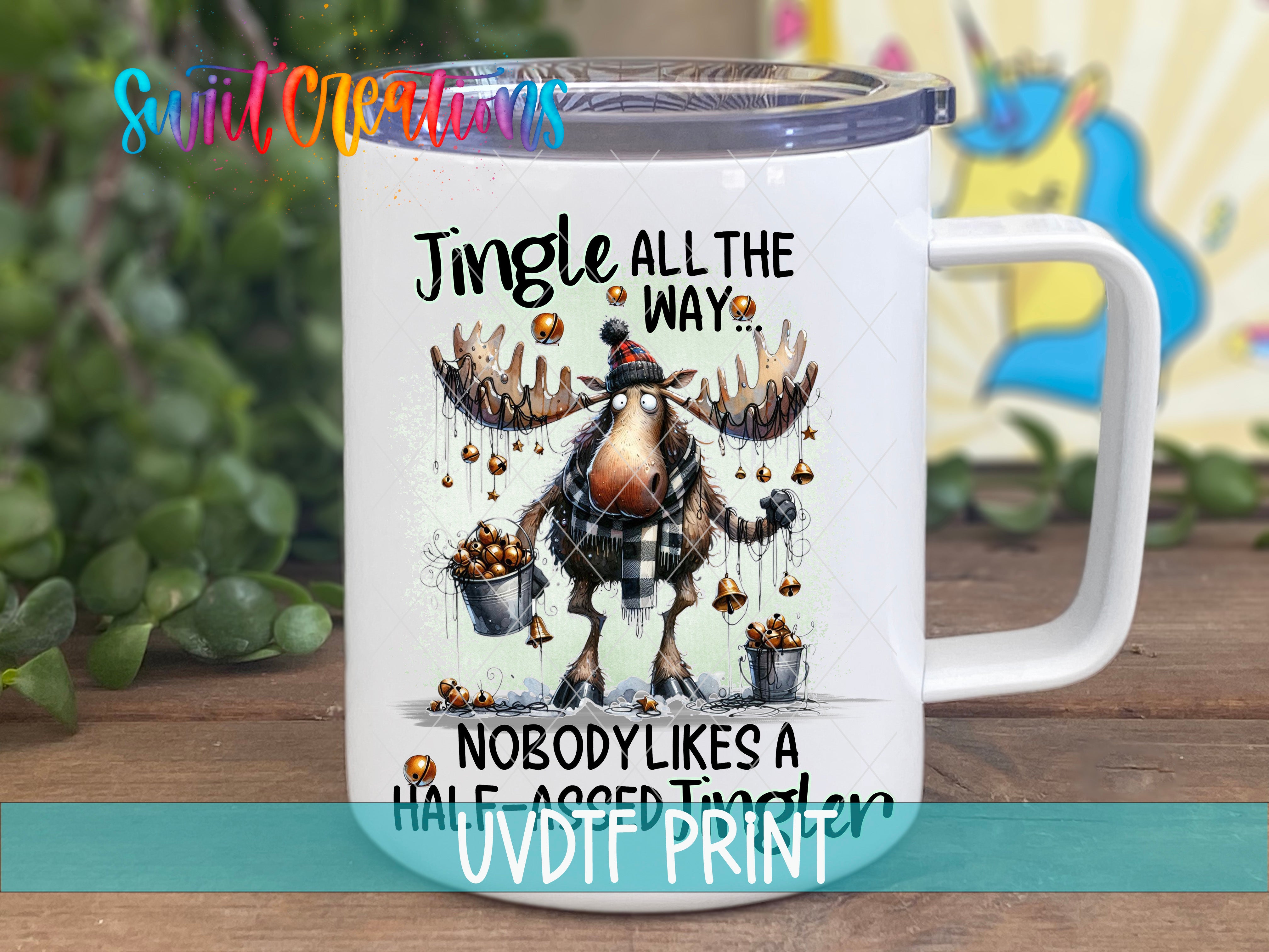 A white mug with a cartoon moose and the text "Jingle all the way" printed on it.