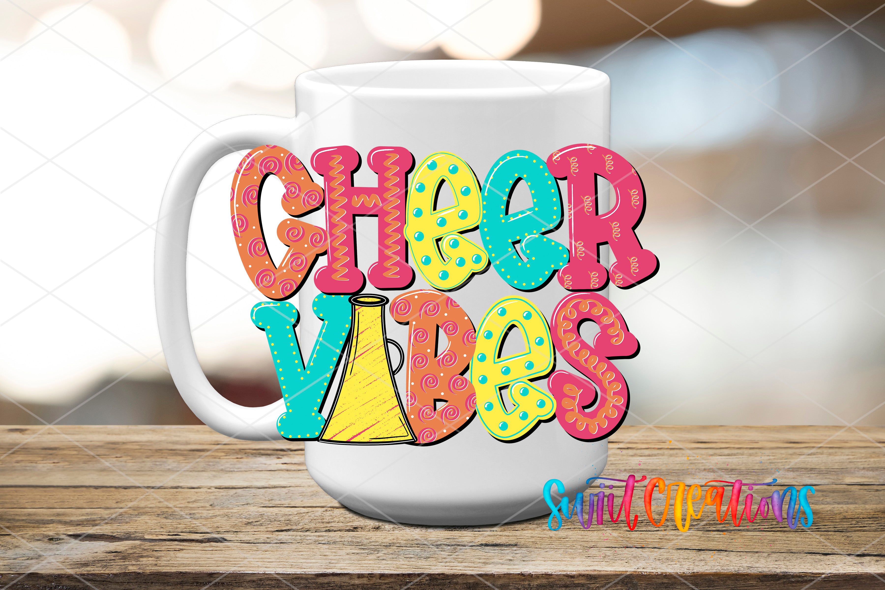 A white mug with colorful text that says "CHEER VIBES" on it, placed on a wooden surface.