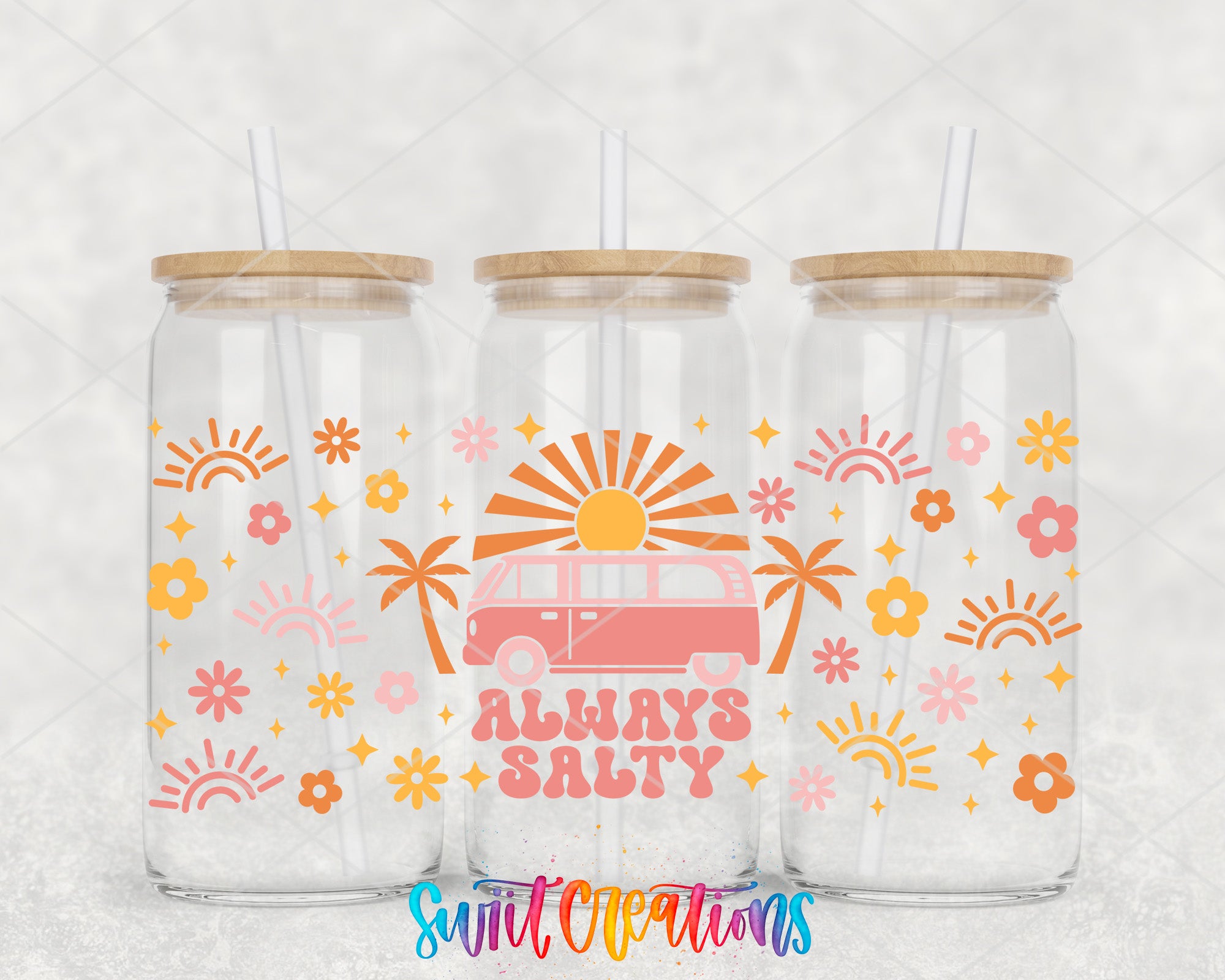 three clear glass tumblers with wooden lids, each adorned with a vibrant, retro-style design. The designs include sun motifs, flowers, and palm trees, creating a cheerful and tropical aesthetic. The text "Always Salty" is prominently displayed on the tumblers, adding a playful and humorous touch to the overall design.