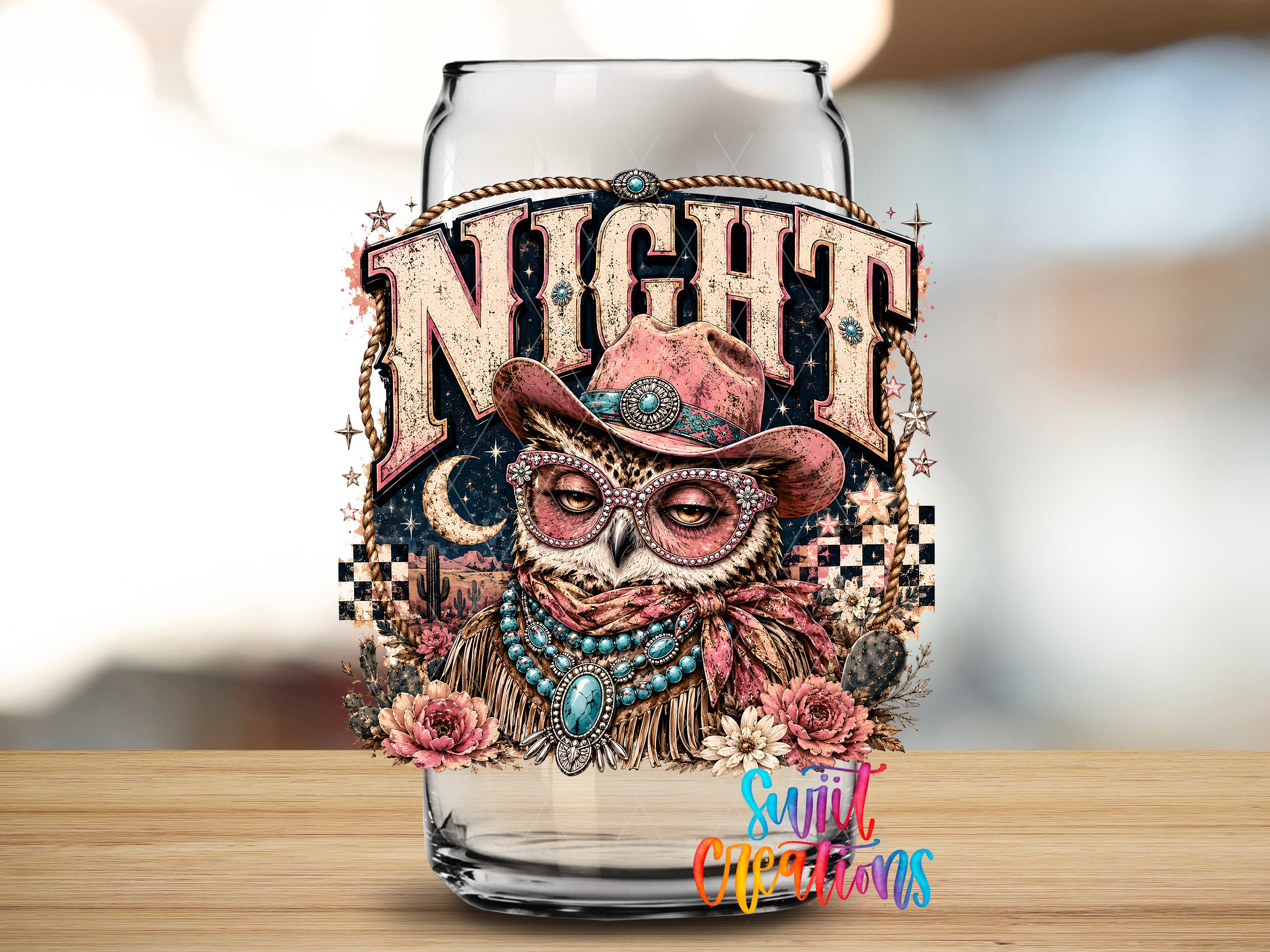 A glass jar with an owl wearing a cowboy hat and surrounded by flowers and other decorative elements.