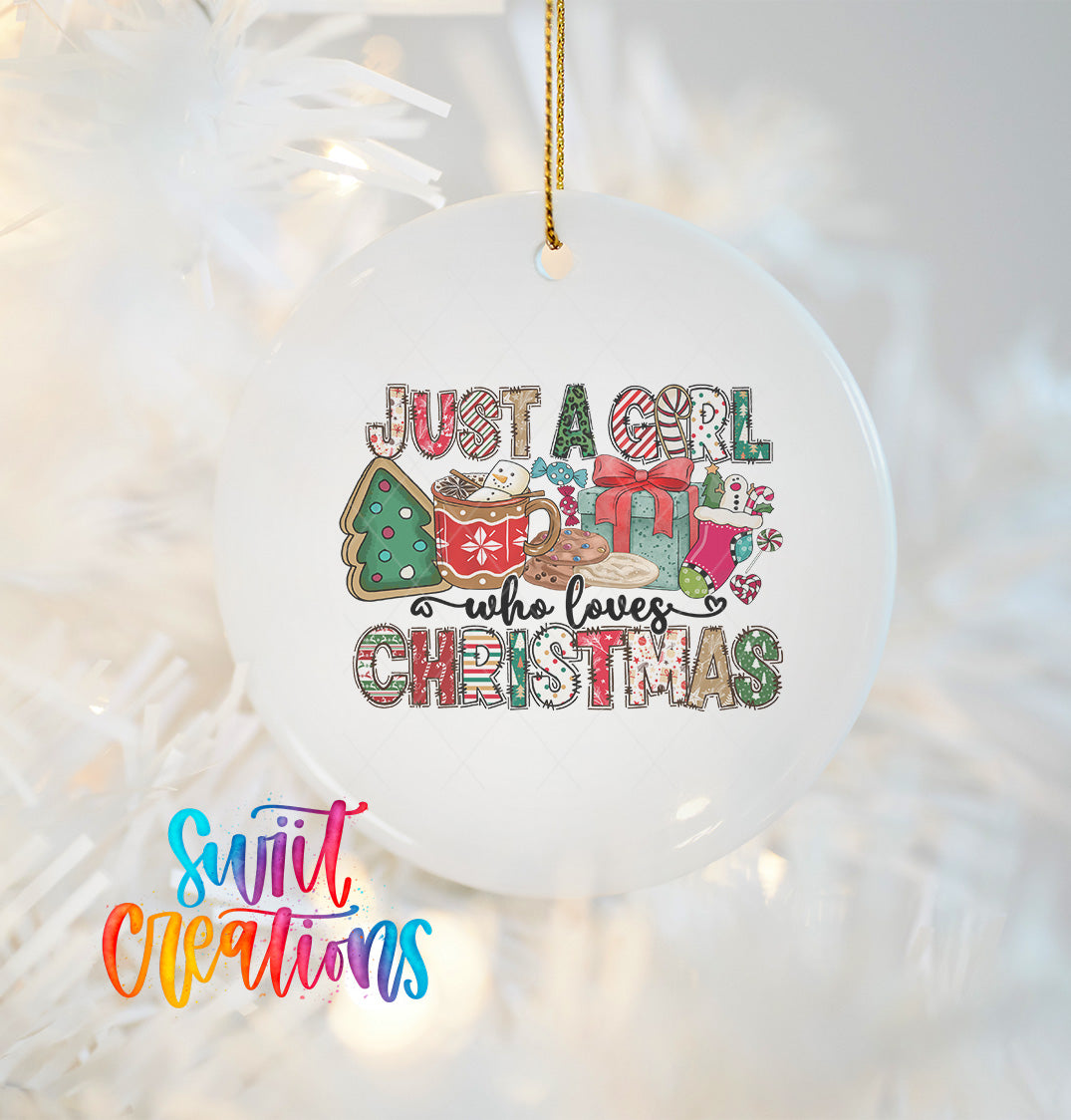 A white ornament with a colorful design hanging on a Christmas tree.