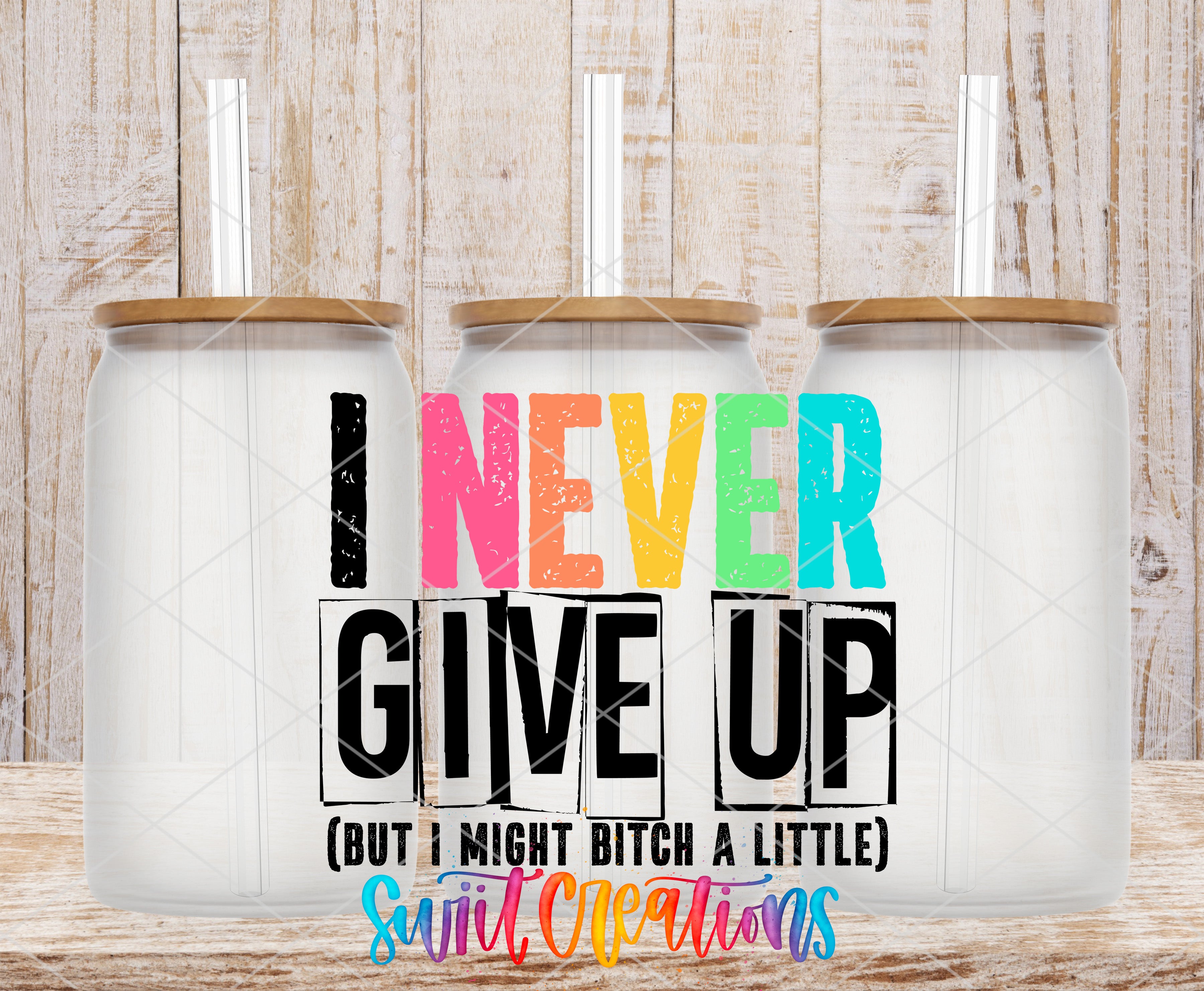 Three clear glass cans with the I Never Give Up UV DTF transfer by Swiit Creations