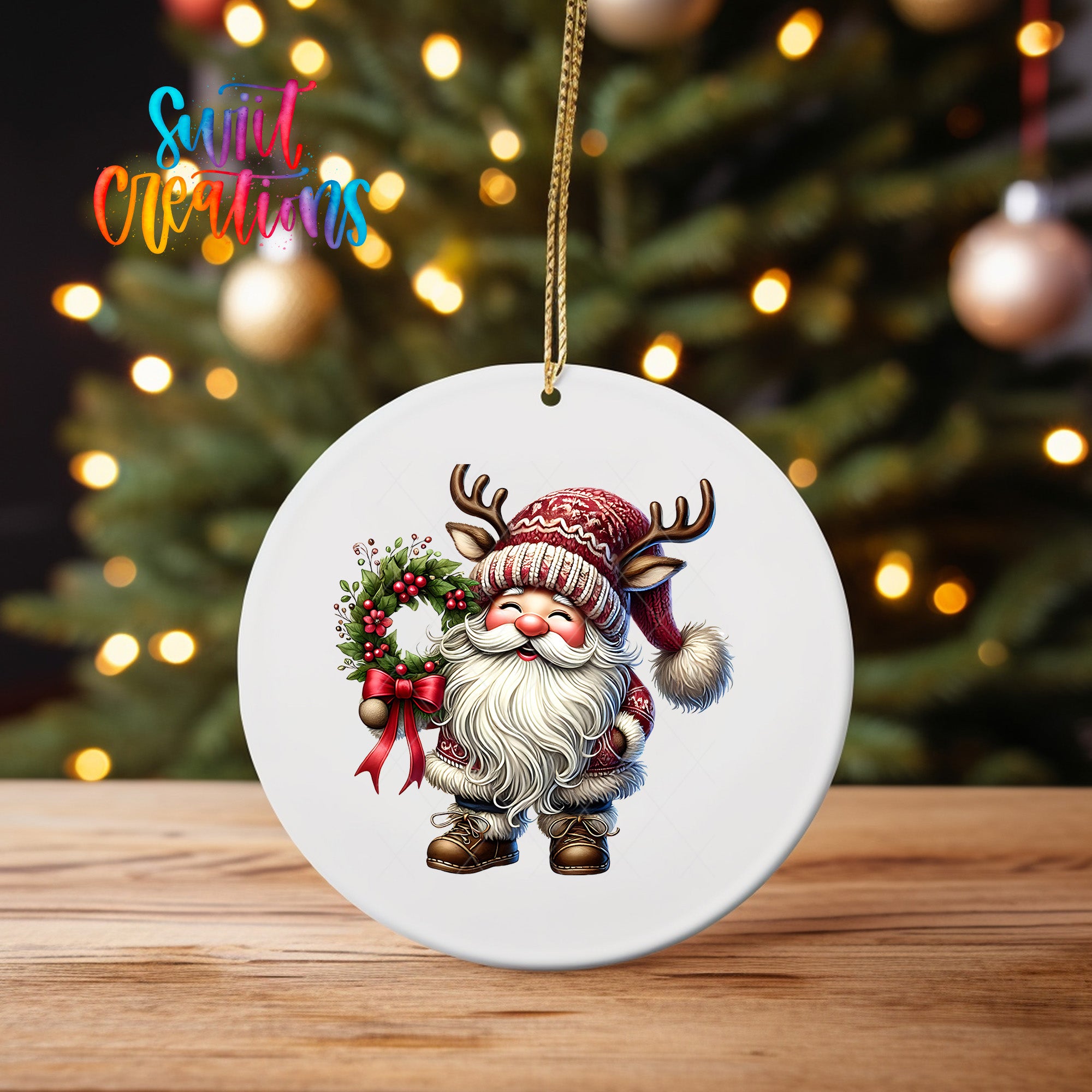 A white ornament featuring a Santa Claus figure holding a wreath and wearing a red and white hat, with a blurred background of a Christmas tree and colorful lights.