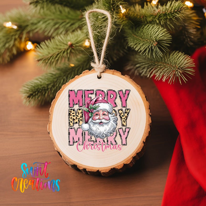 A wooden ornament with a Santa Claus image and the text "MERRY MARY CHRISTMAS" hanging on a Christmas tree.