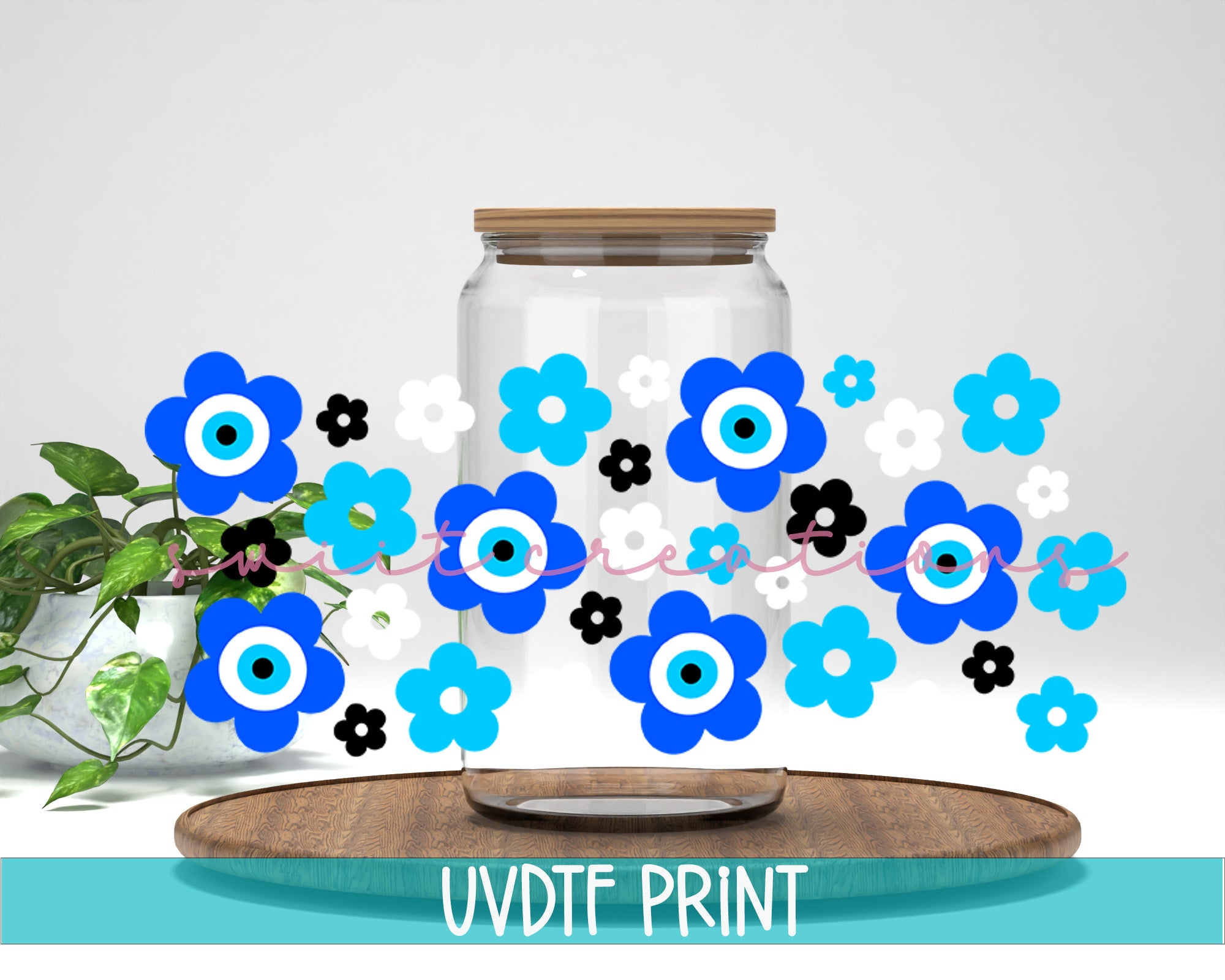 a glass jar with blue and black flowers in it