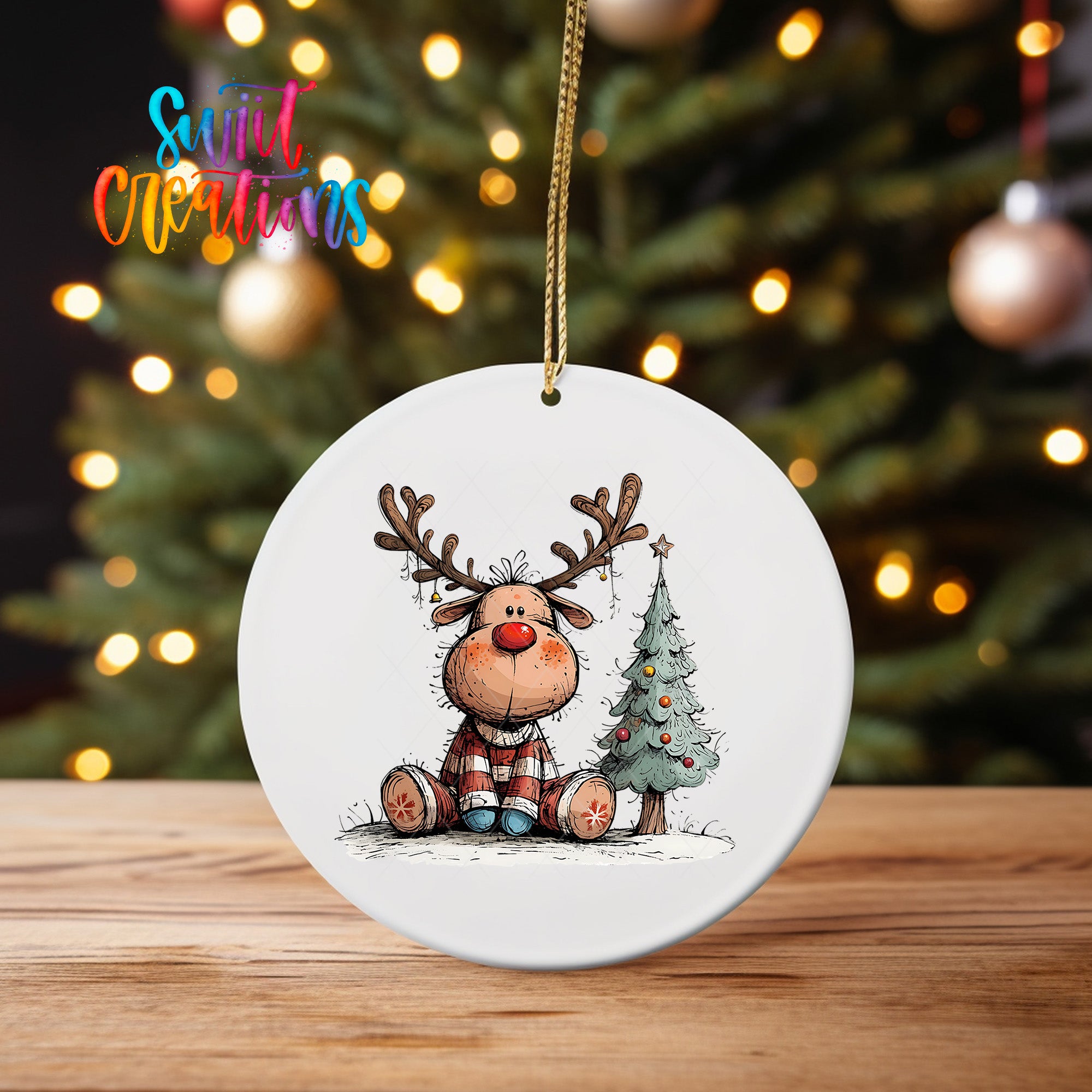 A white ceramic ornament featuring a cartoon reindeer sitting next to a Christmas tree, with a colorful background of lights.