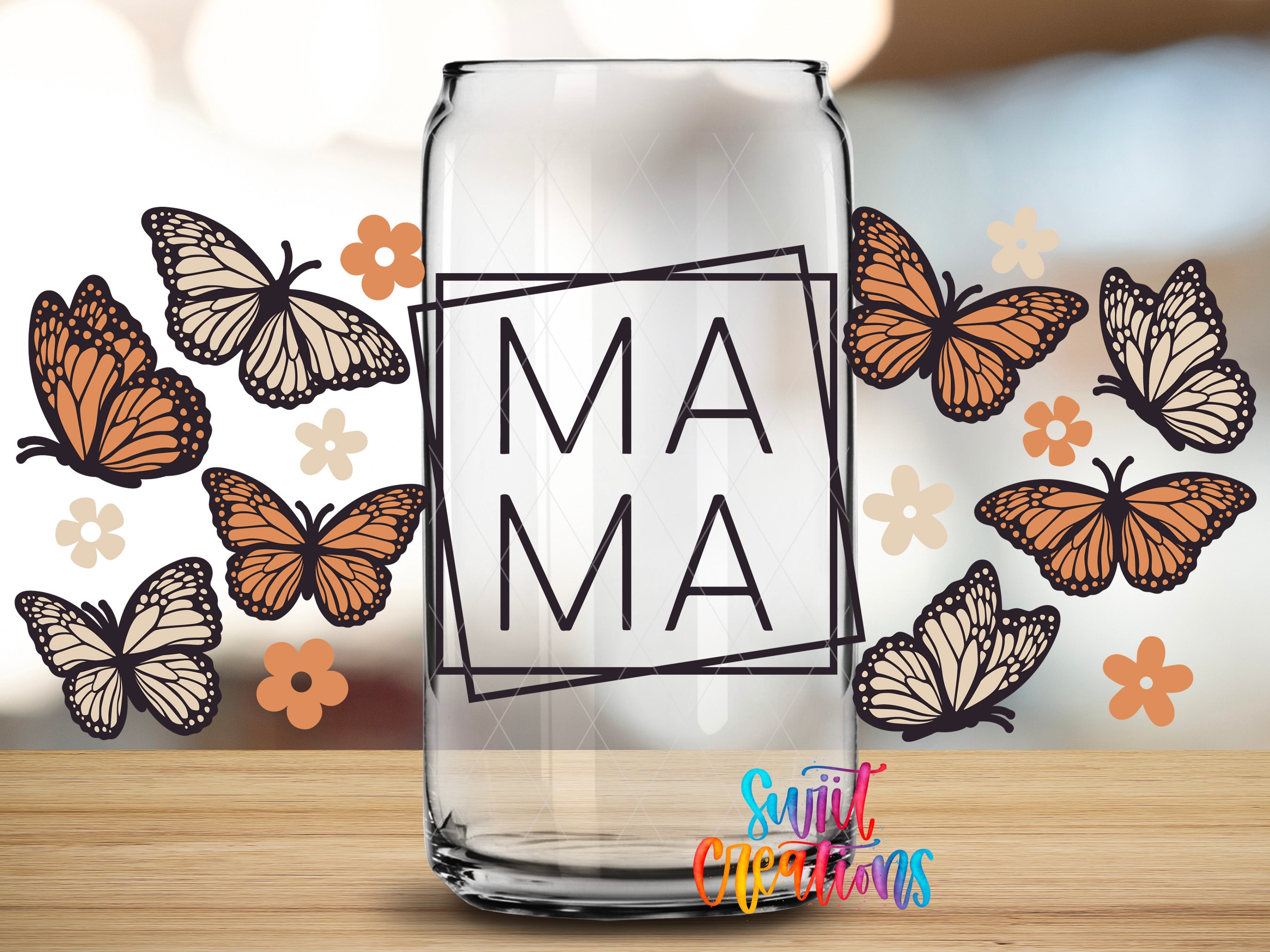 A clear glass can with the word "MAMA" printed on it, surrounded by various butterflies and flowers.