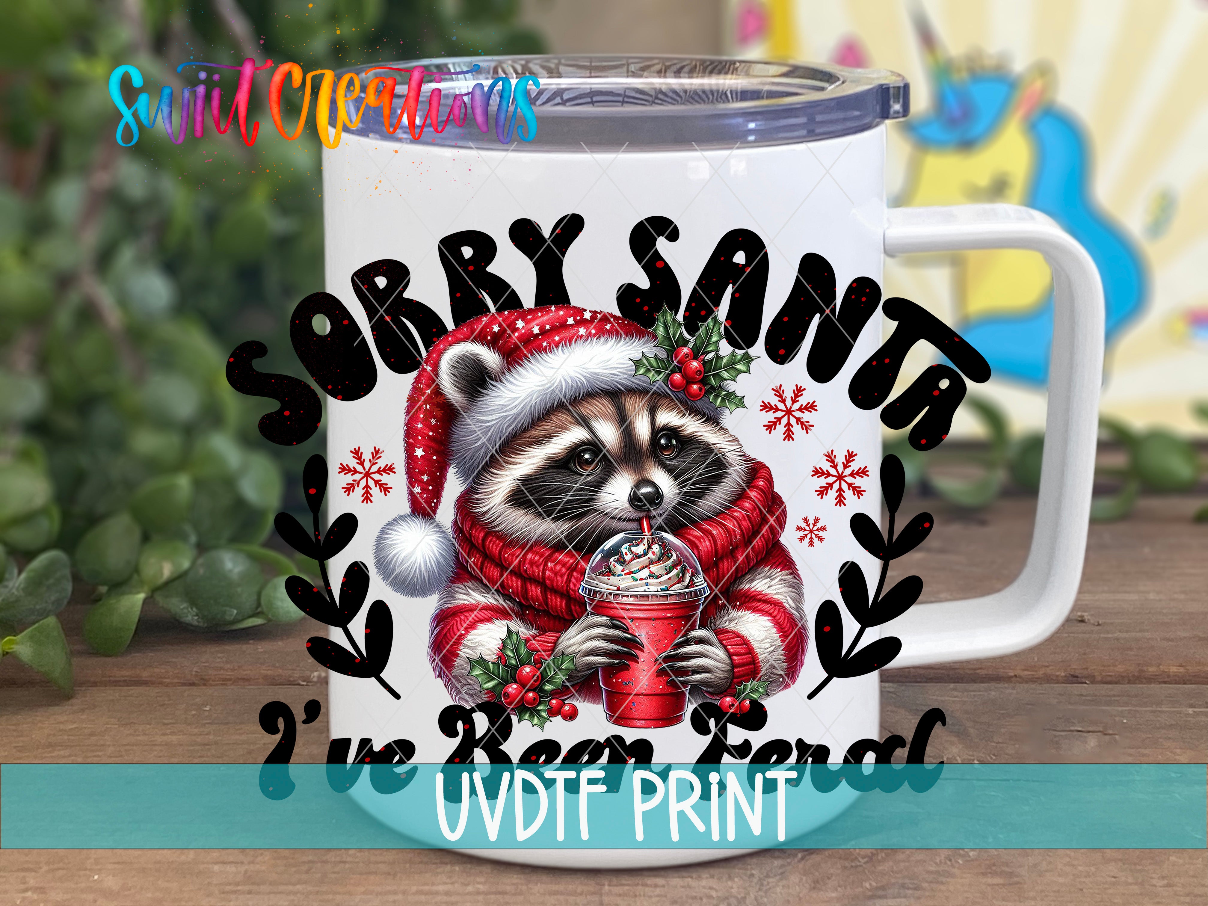 a white coffee mug with a raccoon wearing a santa hat and holding a