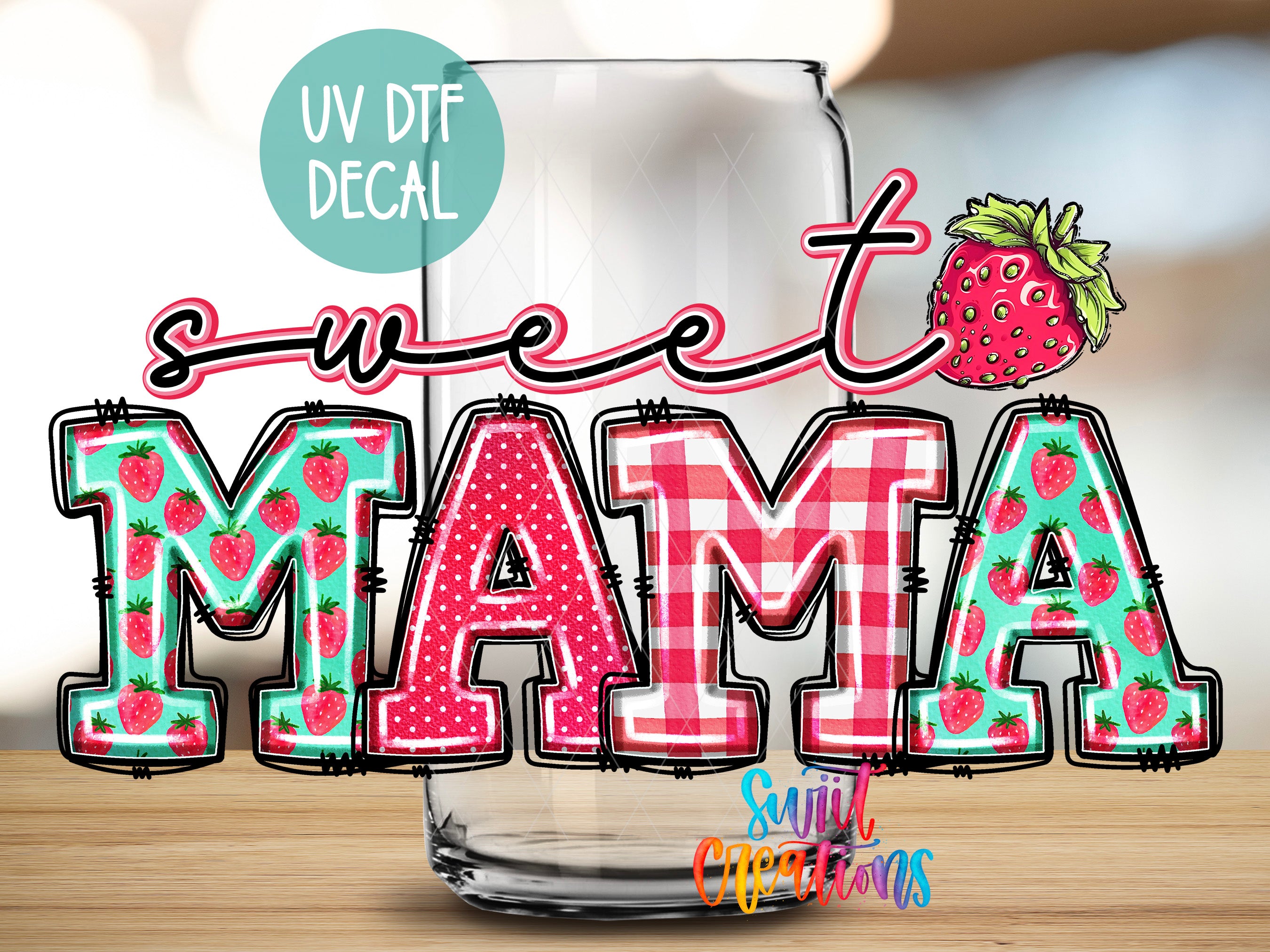 a glass with the word "MAMA" written on it, along with a strawberry decoration.