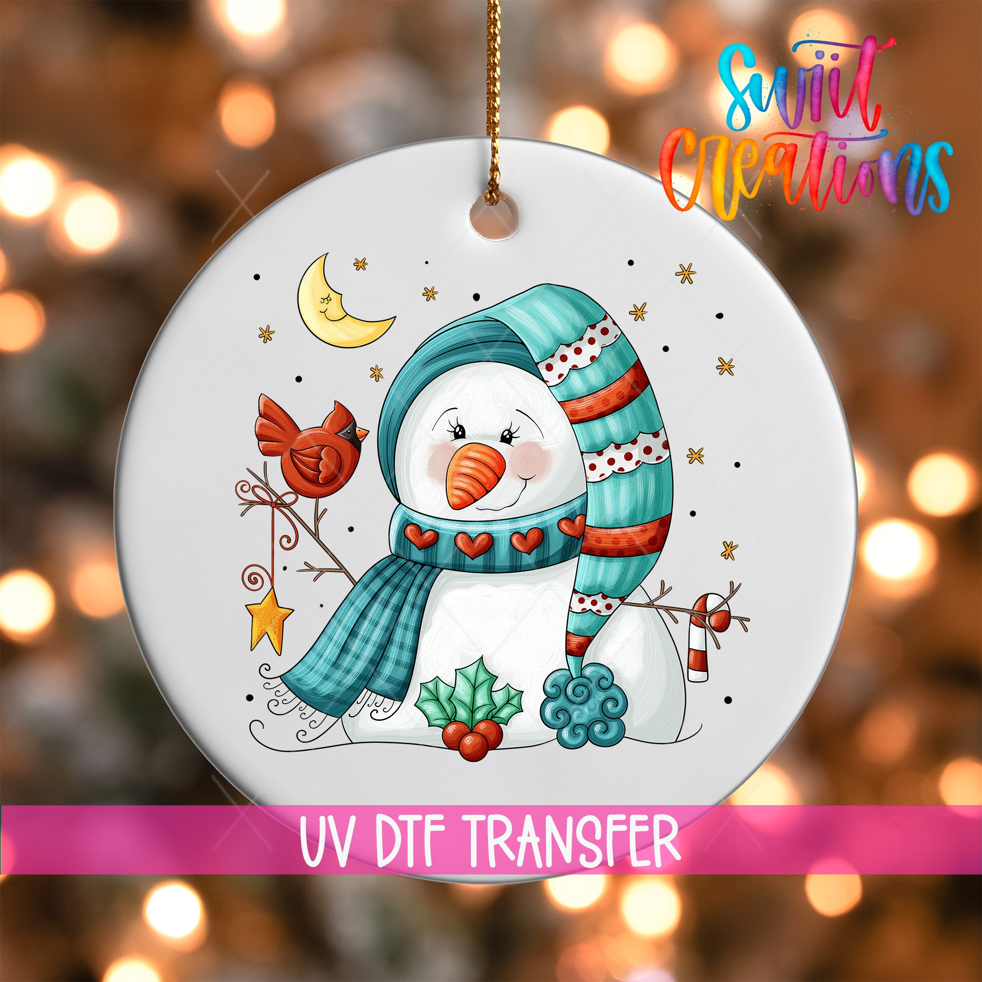 A snowman ornament with a scarf, hat, and other winter-themed decorations, including a bird and a crescent moon, is hanging on a string.
