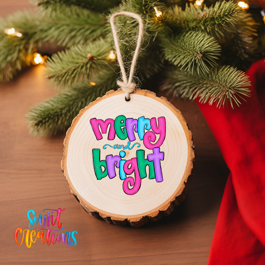 A wooden ornament with the text "mercy and bright" is hanging on a Christmas tree, surrounded by pine branches and twinkling lights.
