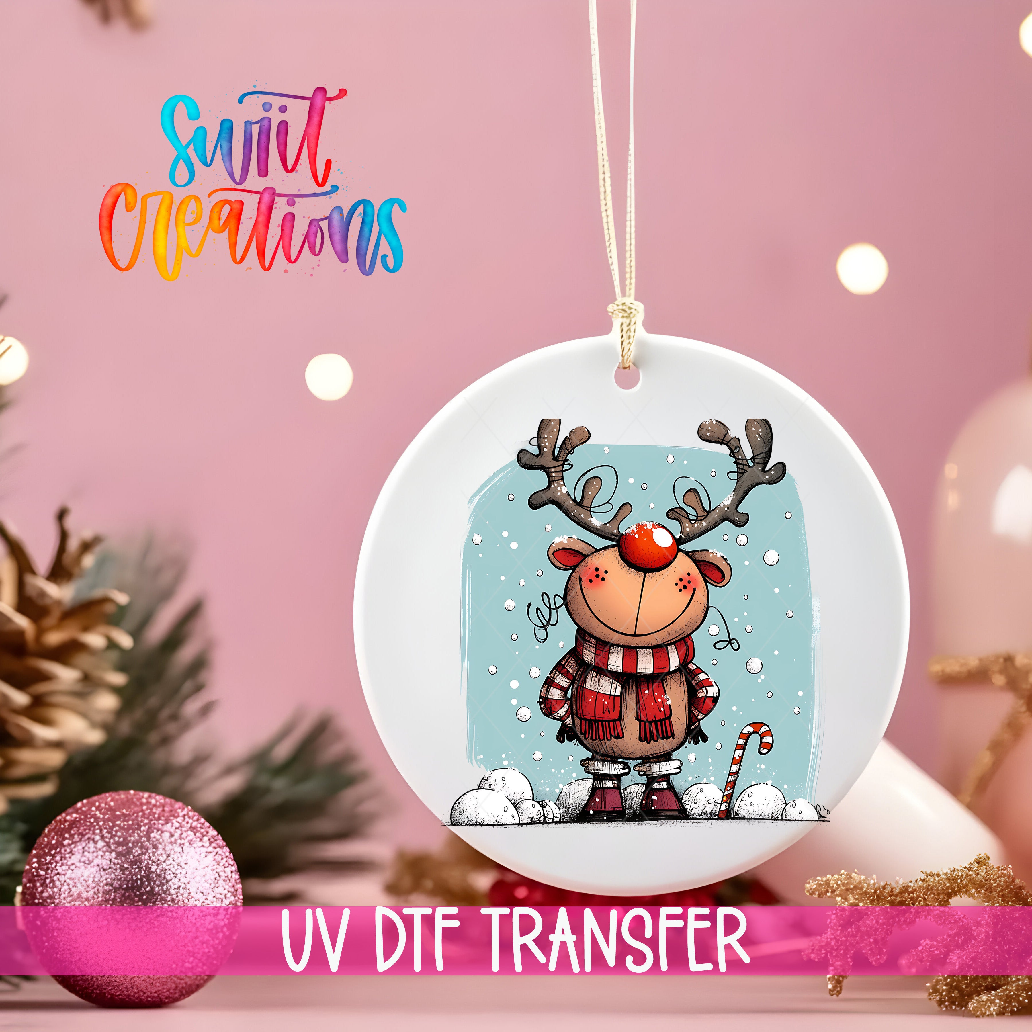 A white ceramic ornament with a cartoon reindeer and snowflakes, hanging on a string against a pink background with Christmas decorations.