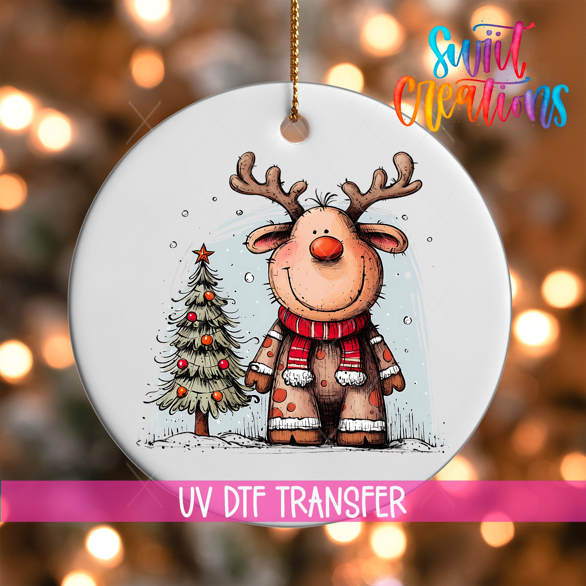 A white ornament featuring a cartoon reindeer with antlers and a Christmas tree, with a pink ribbon below the ornament.