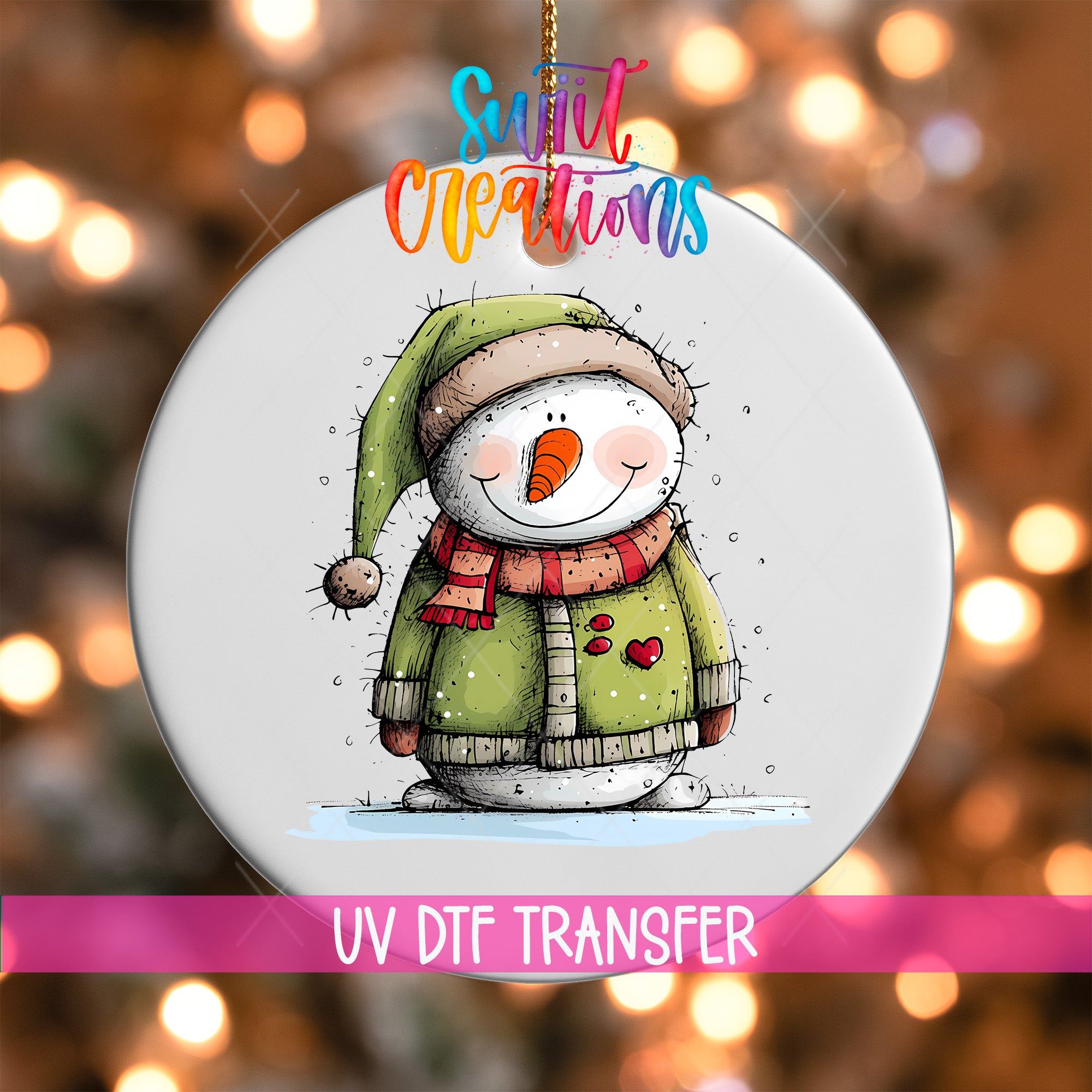 A snowman ornament with a green hat and scarf, and a red heart on its chest, is hanging against a background of colorful lights.