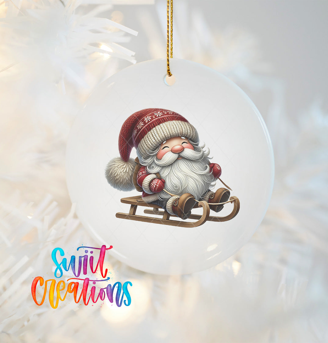 A white ornament featuring a smiling Santa Claus on a sled, with a colorful text overlay that reads "Swift Creations".