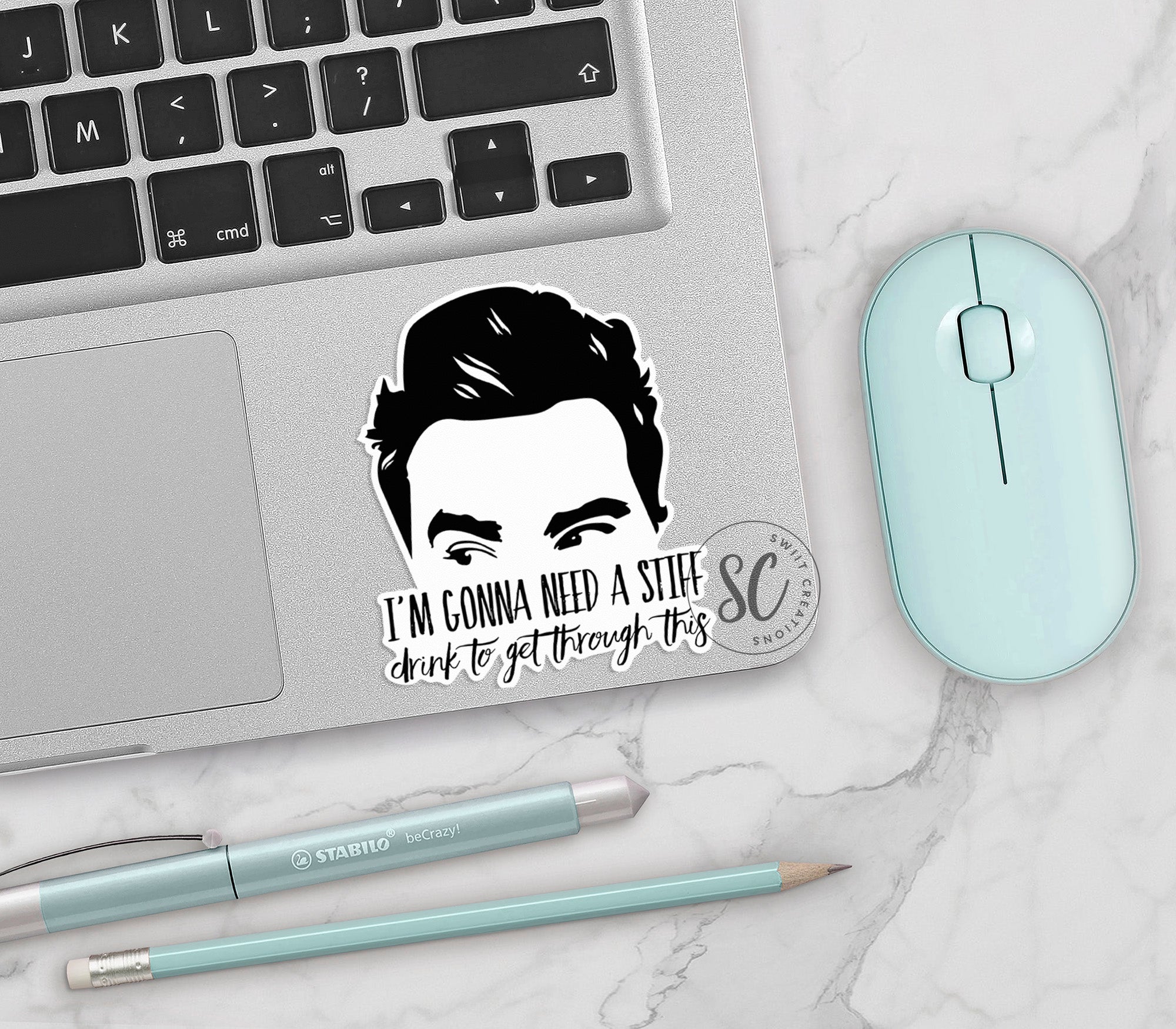 a laptop with a sticker of a man's face on it