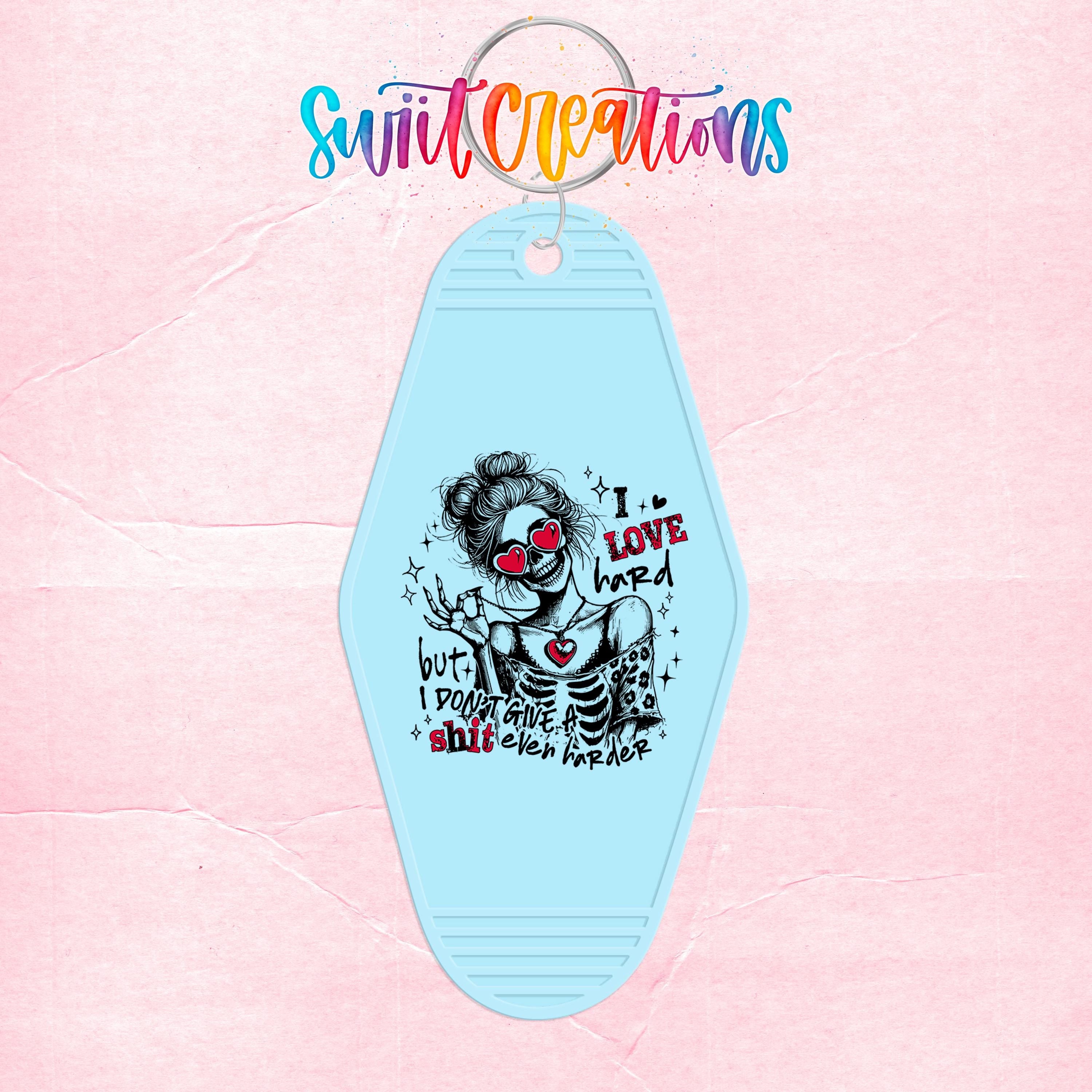 A keychain with a graphic design featuring a skeleton wearing sunglasses and the text "I I LOVE HARD HARDER" printed on it.