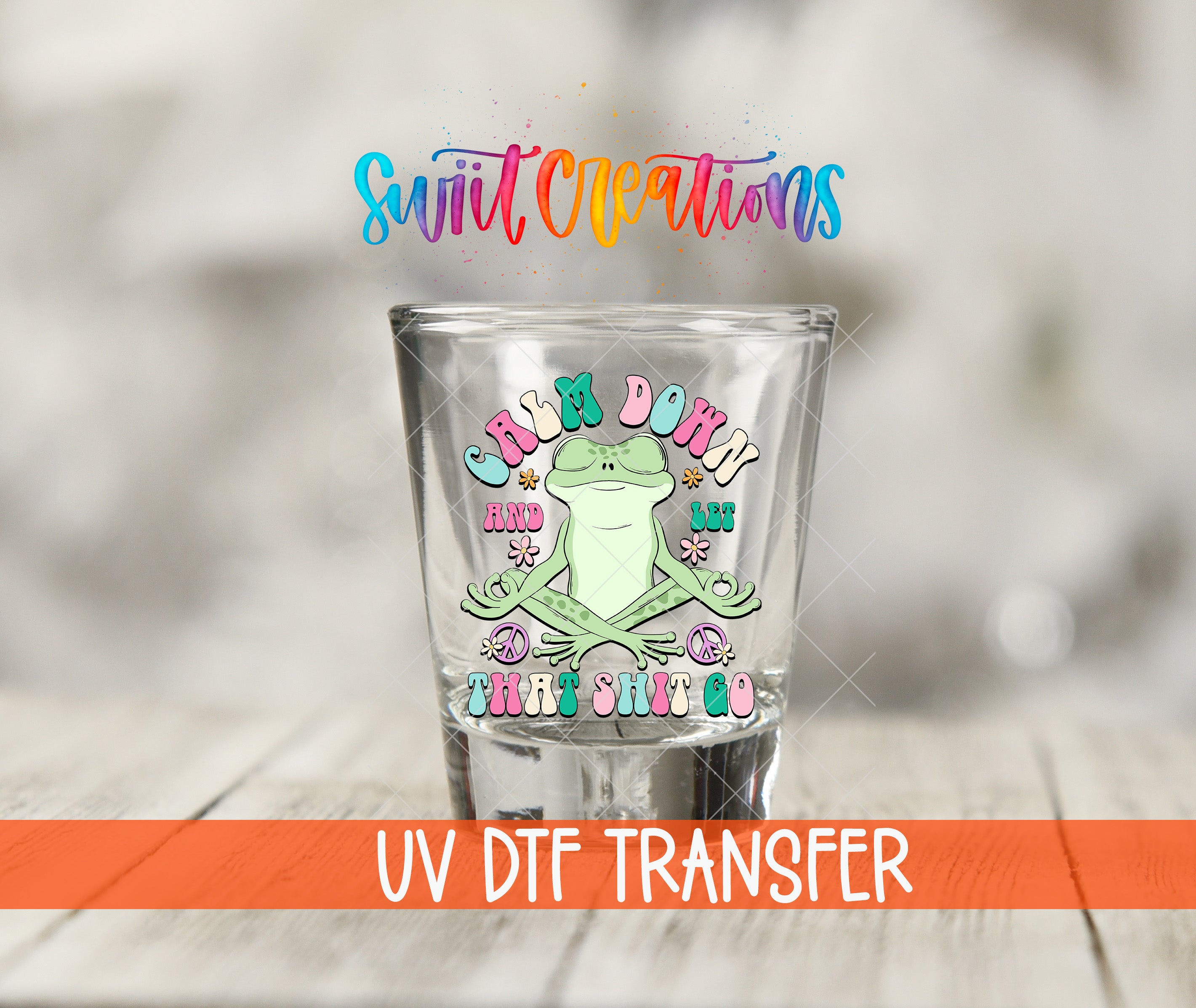 A shot glass with a colorful frog design and text, along with the text "Swift Creations" and "UV Dtf Transfer" below it.