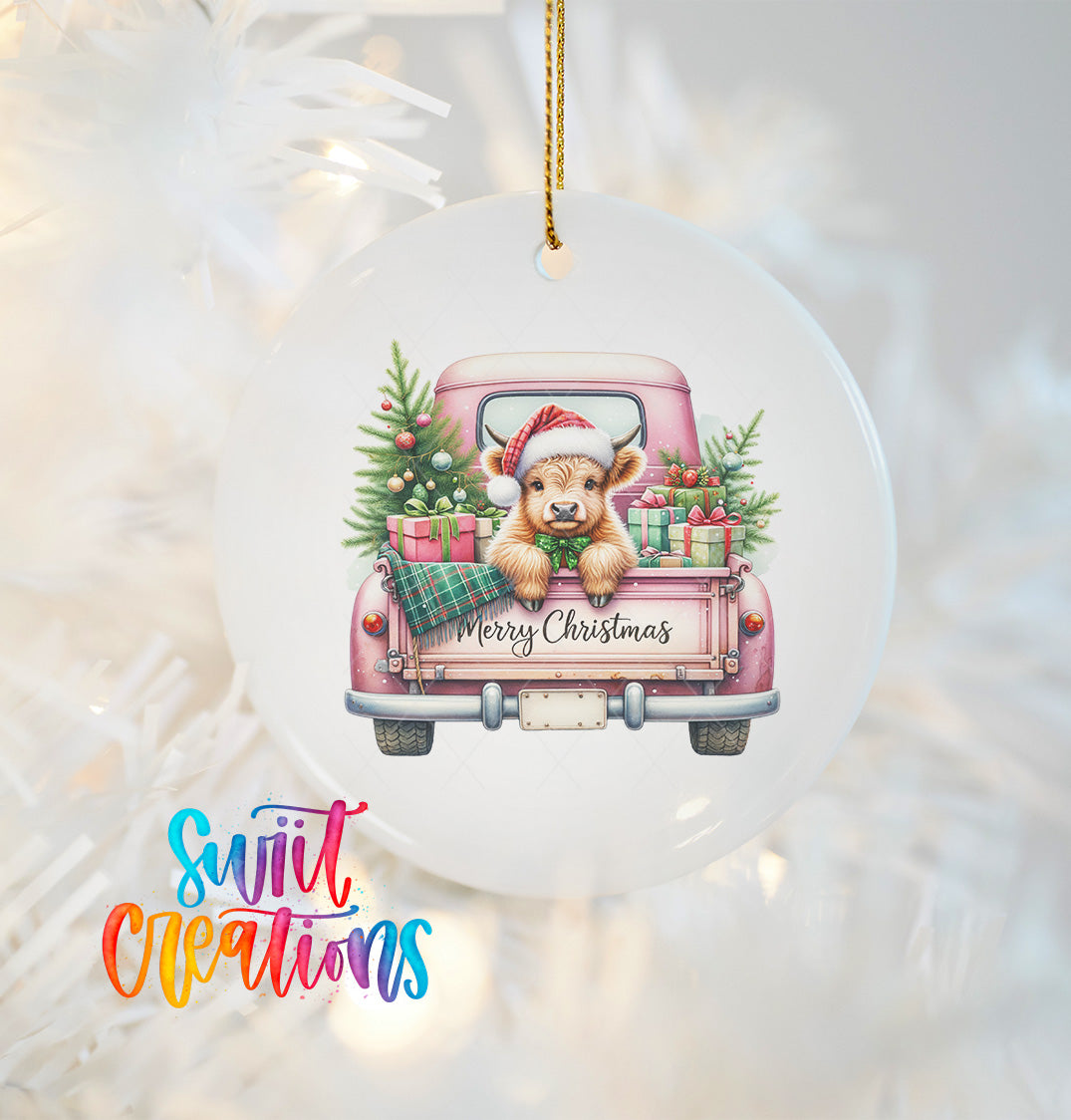 A white Christmas ornament featuring a cartoon cow in a pink truck, surrounded by Christmas decorations and the text "Merry Christmas".