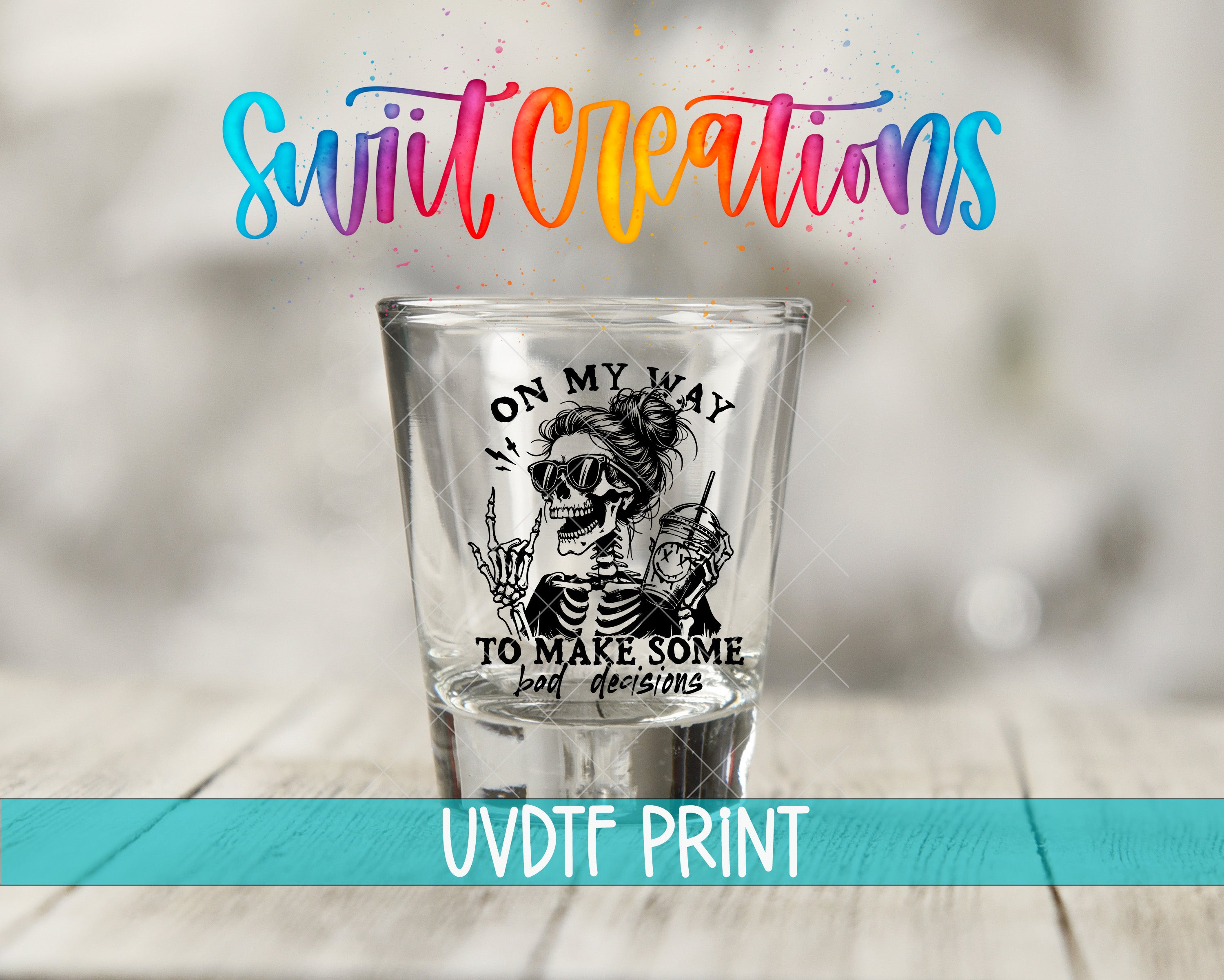 A shot glass with a skeleton design and text printed on it, along with colorful text above the shot glass.