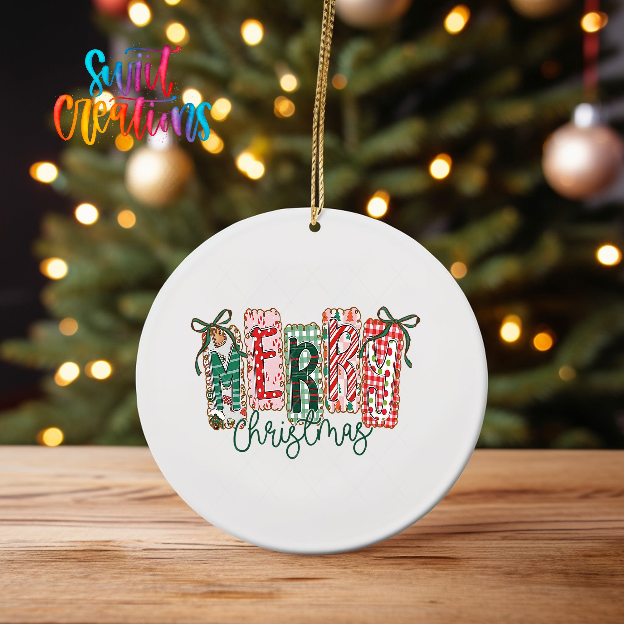 A white ceramic ornament with the text "MERRY CHRISTMAS" printed on it, hanging from a string.
