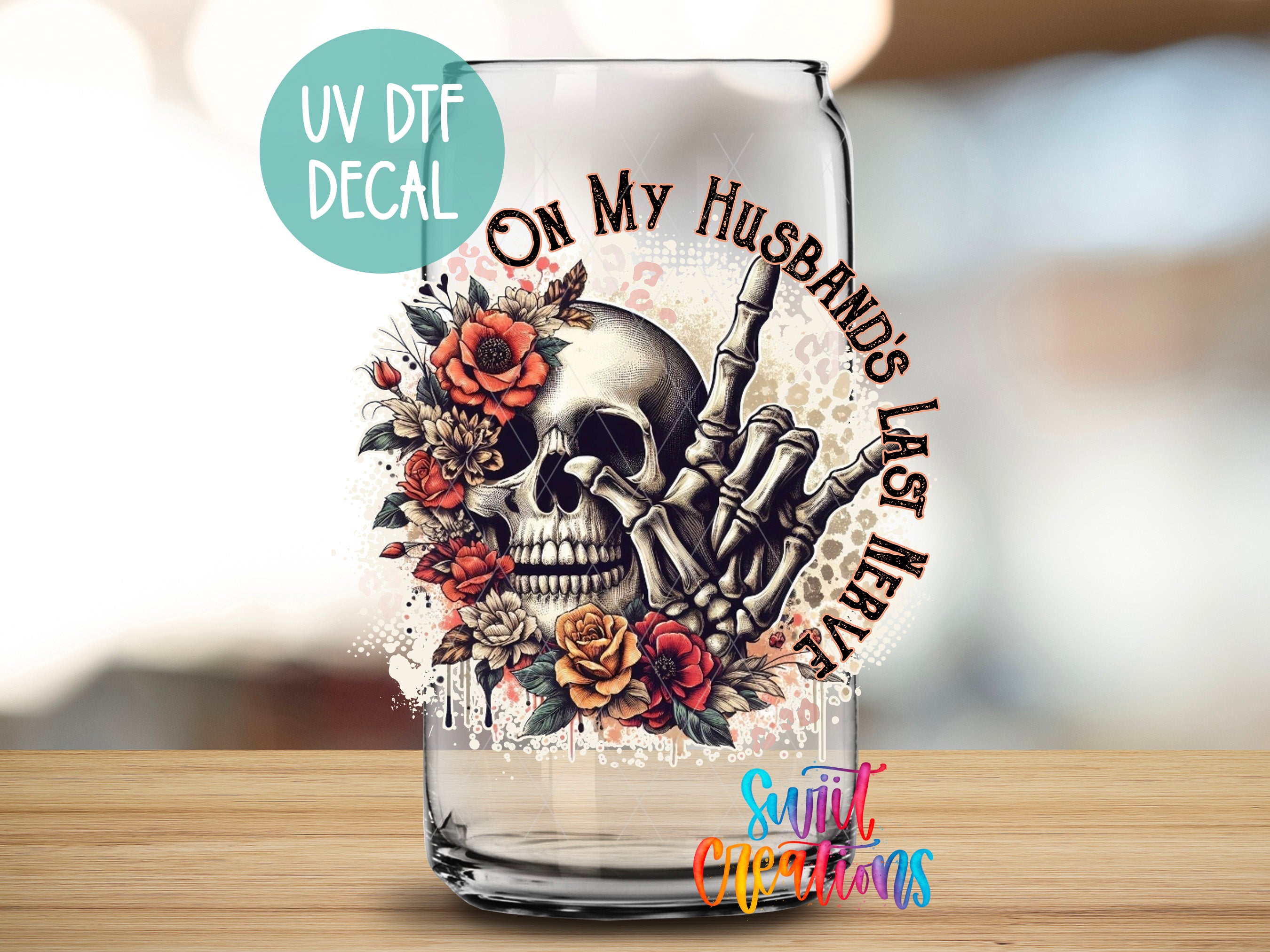 a glass with a skull and flowers on it