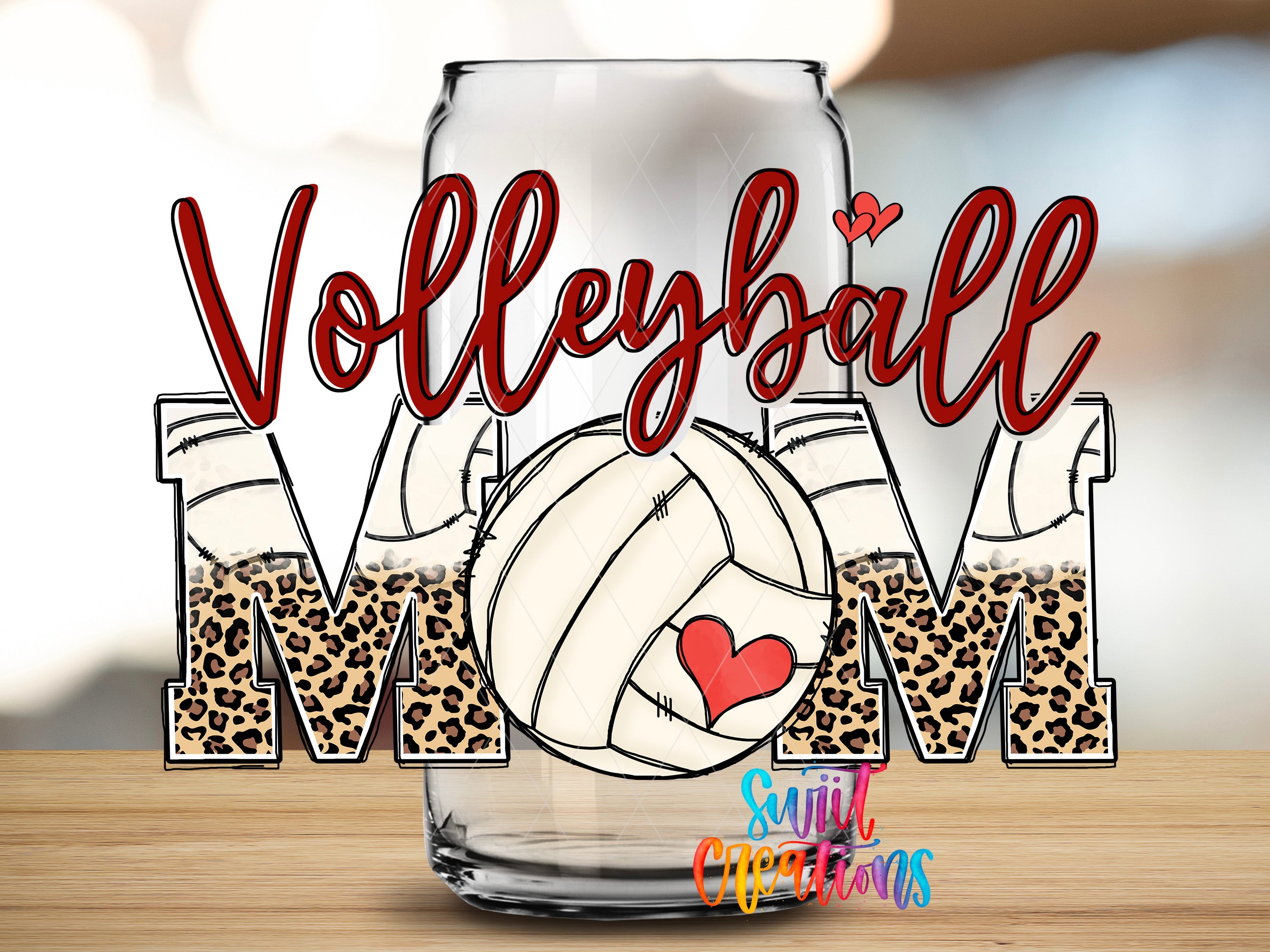 A glass can with the word "Volleyball" written on it, along with a leopard print design and a heart symbol.