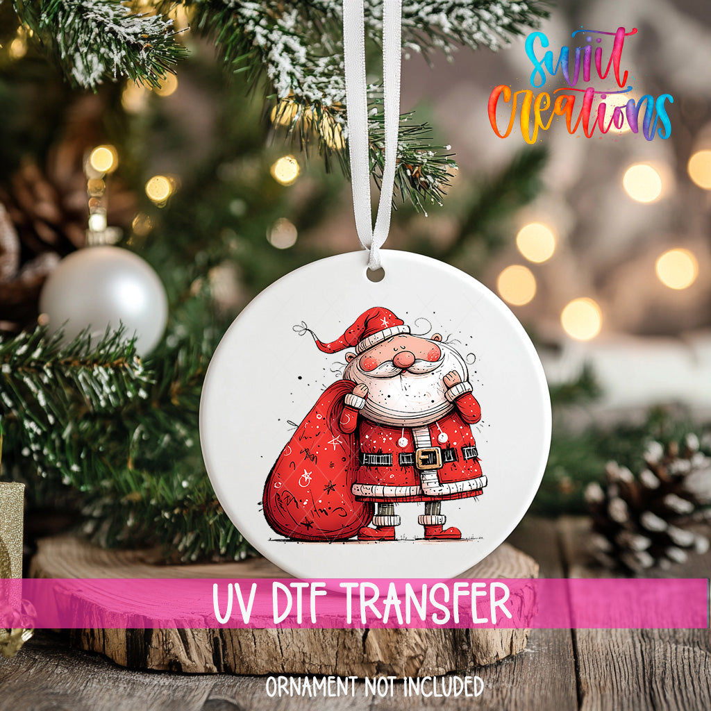 A white ornament with a Santa Claus illustration is hanging on a Christmas tree.