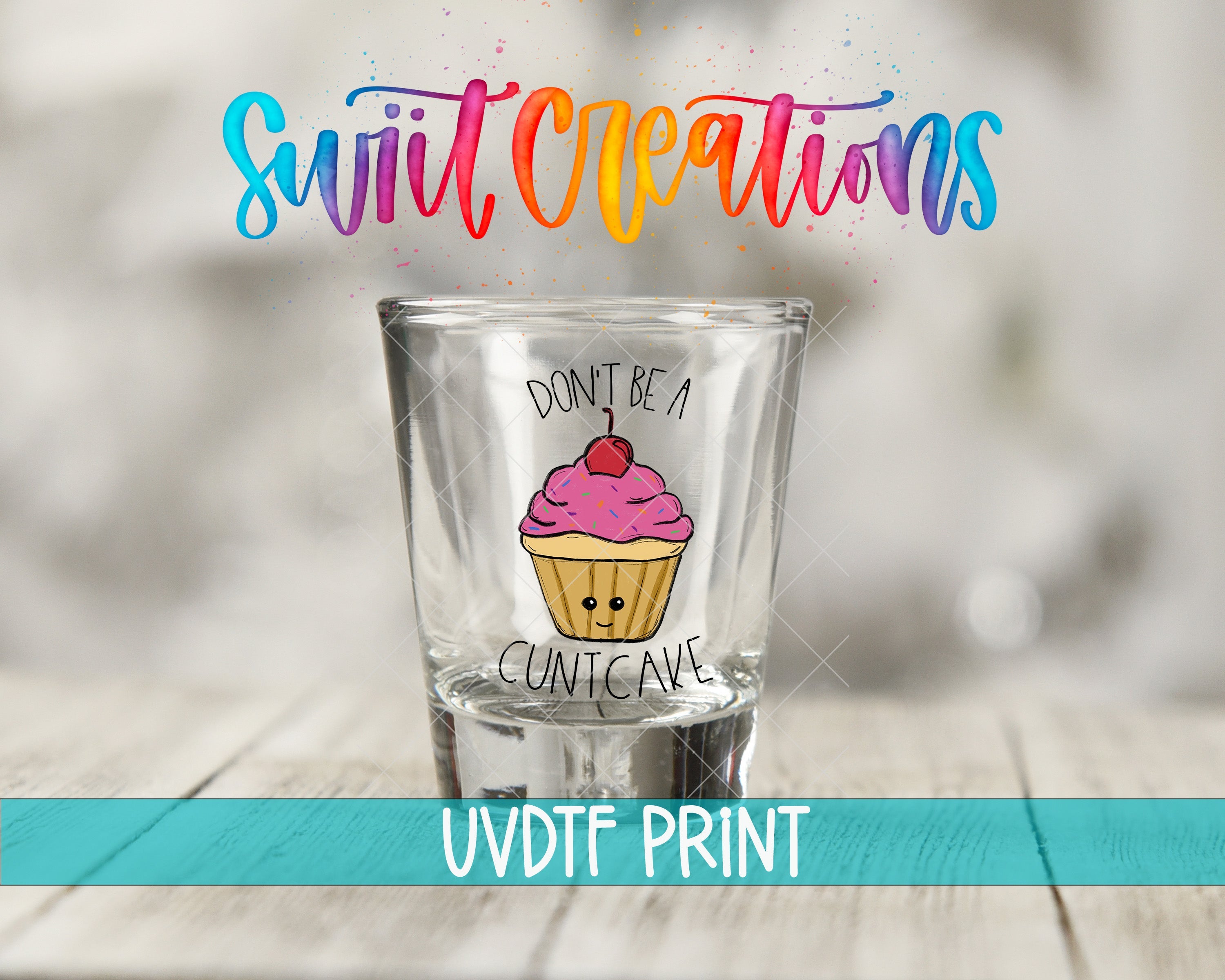 a shot glass with a cupcake drawn on it