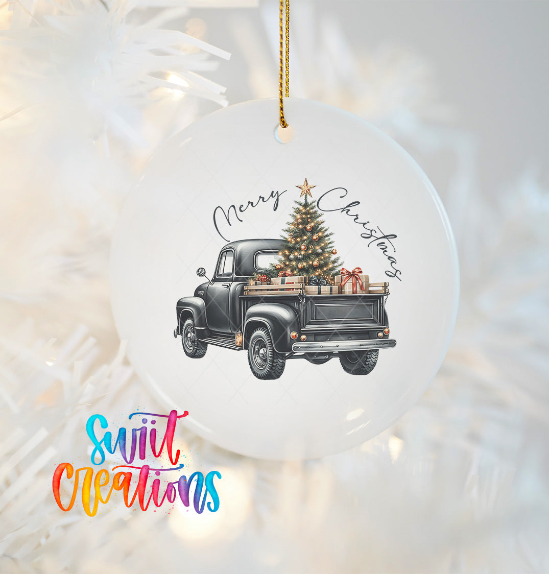 A white Christmas ornament with a black vintage truck carrying a decorated Christmas tree.