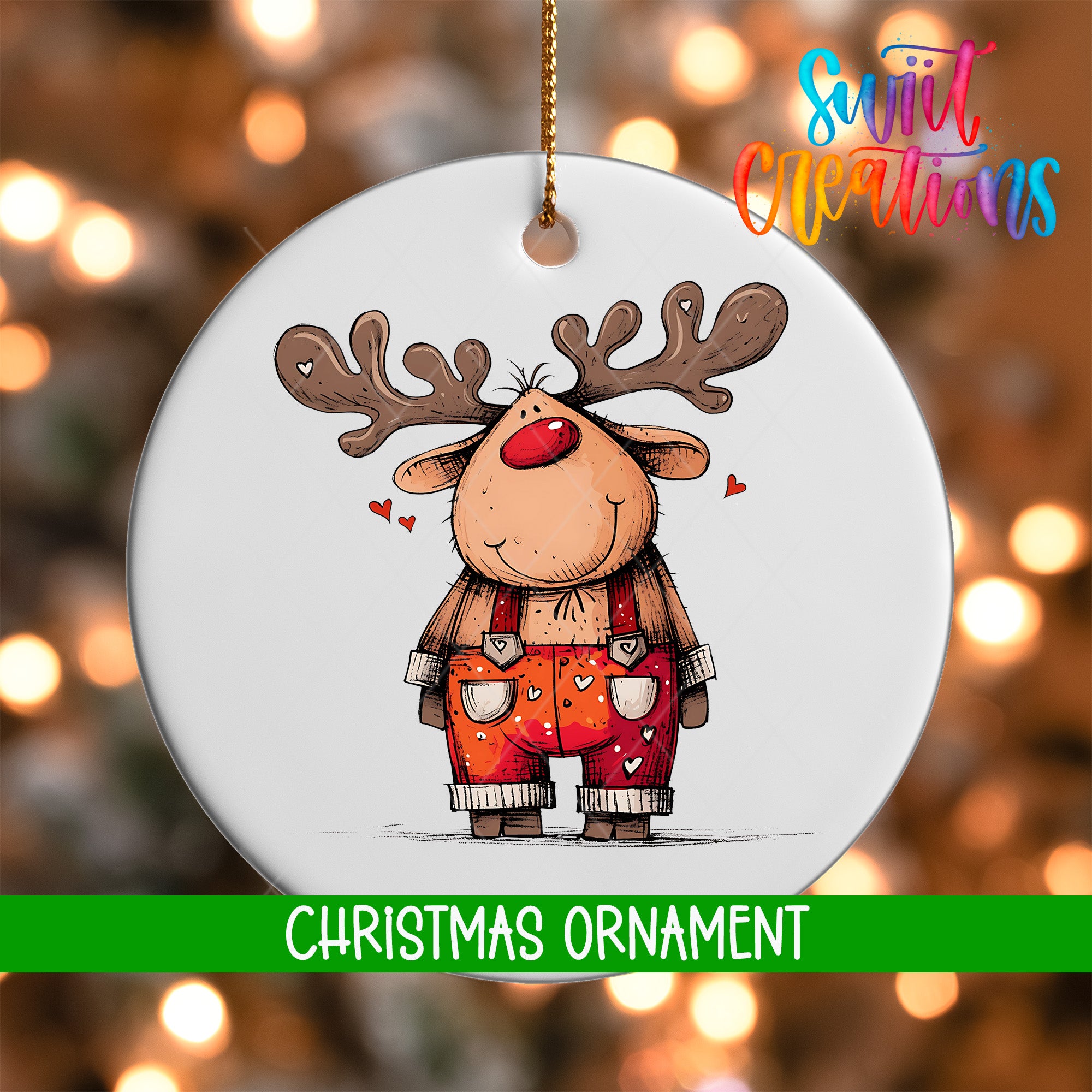 A white Christmas ornament featuring a cartoon reindeer with antlers and a red nose, wearing orange overalls with hearts on them.