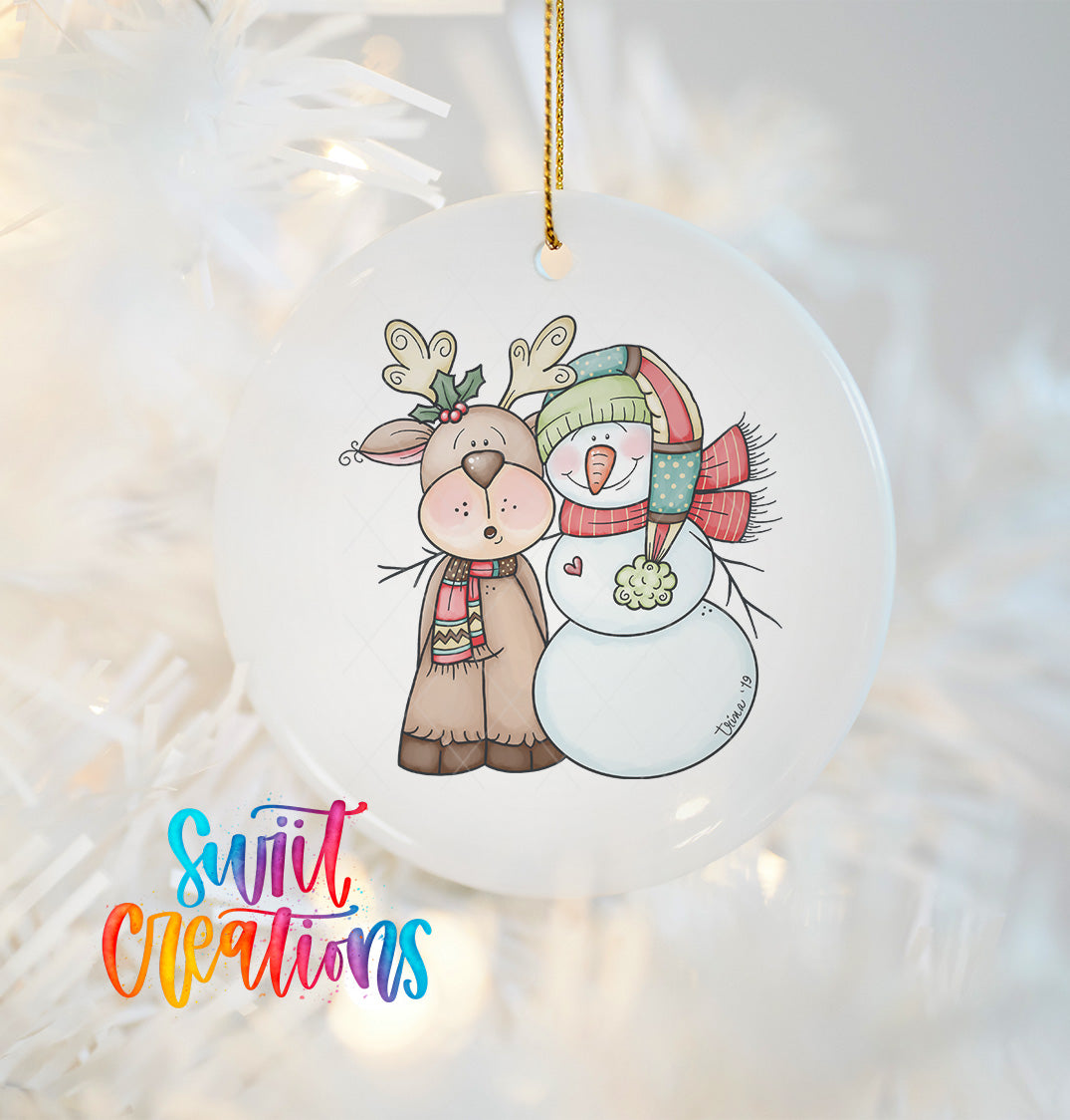 A white ornament featuring a deer and a snowman, with the text "Swift Creations" written in colorful cursive letters.