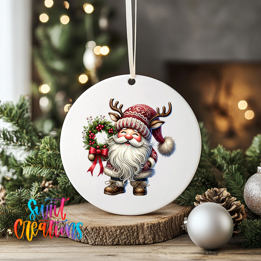 A white ceramic ornament featuring a Santa Claus figure holding a wreath and antlers, surrounded by Christmas decorations and ornaments.
