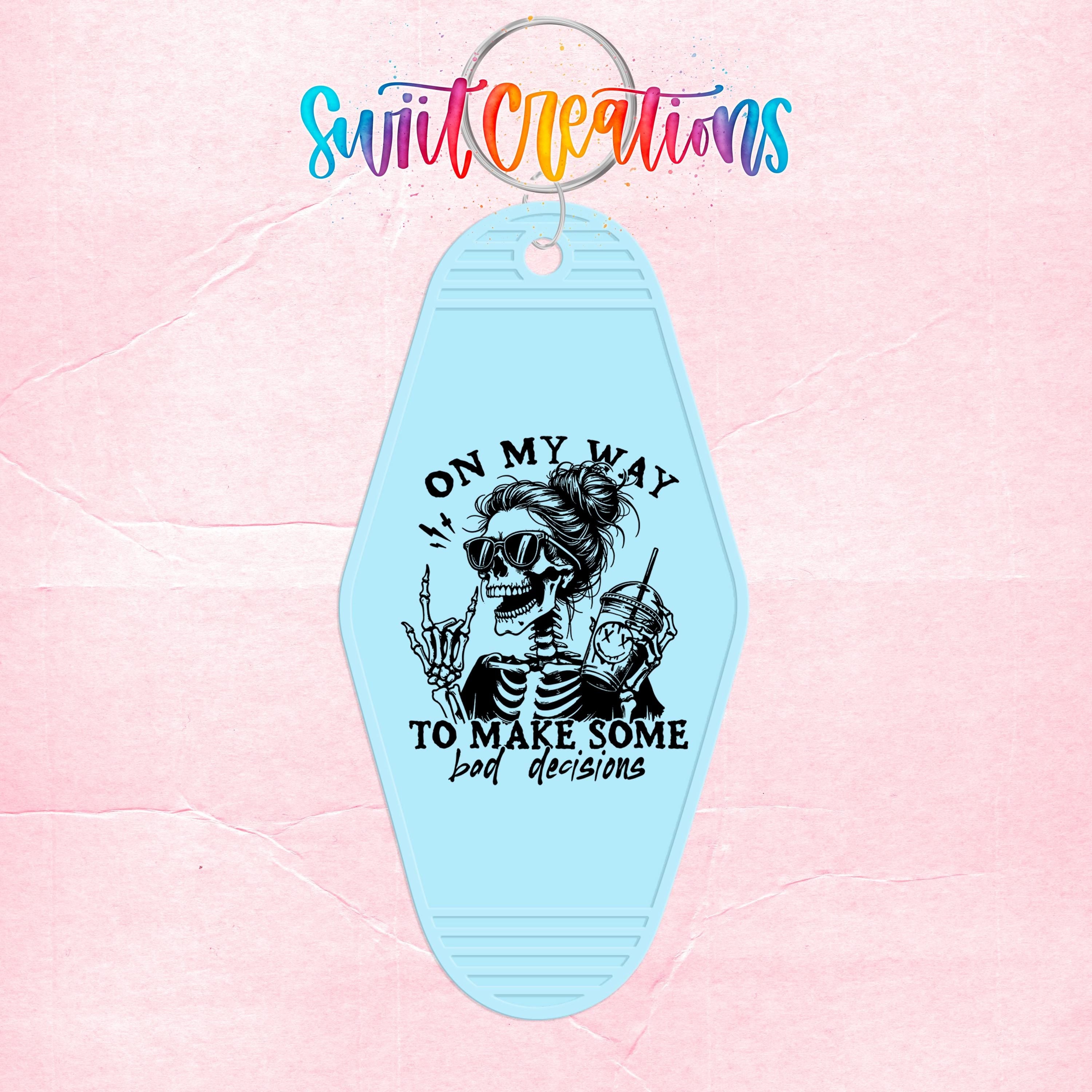 A keychain with a skeleton wearing sunglasses and holding a drink, along with the text "ON MY WAY TO MAKE SOME BAD DECISIONS" printed on it.