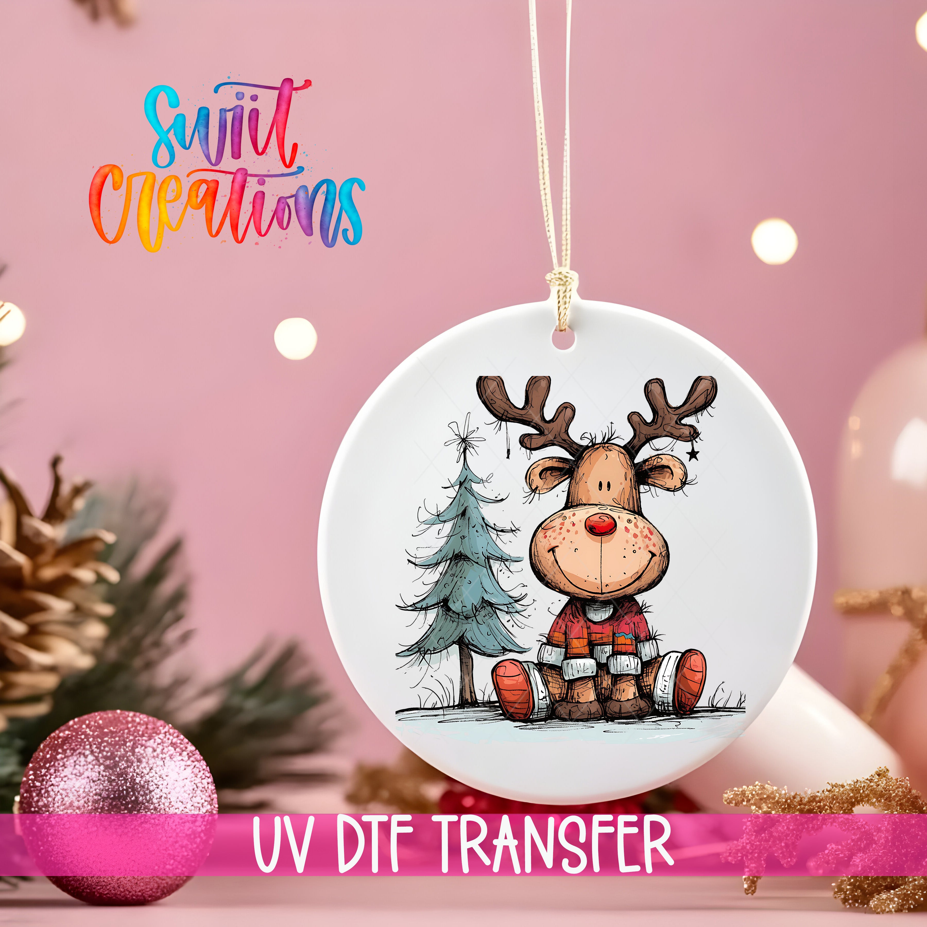 A white ornament with a cartoon reindeer and a Christmas tree is hanging on a string, with a pink background and some Christmas decorations in the background.