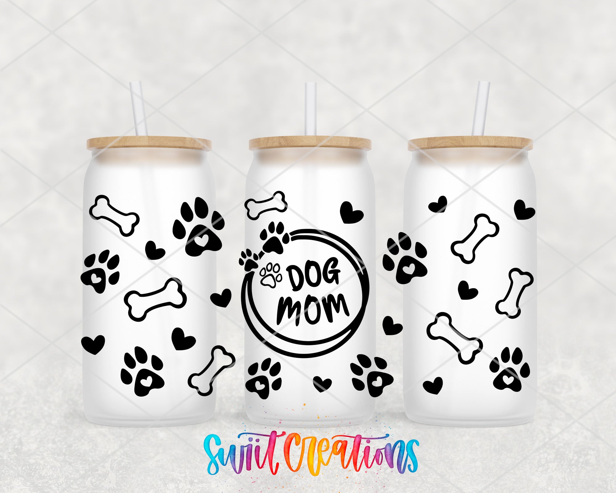 three white tumblers with black paw prints and bones, along with the text "dog mom" printed on them.