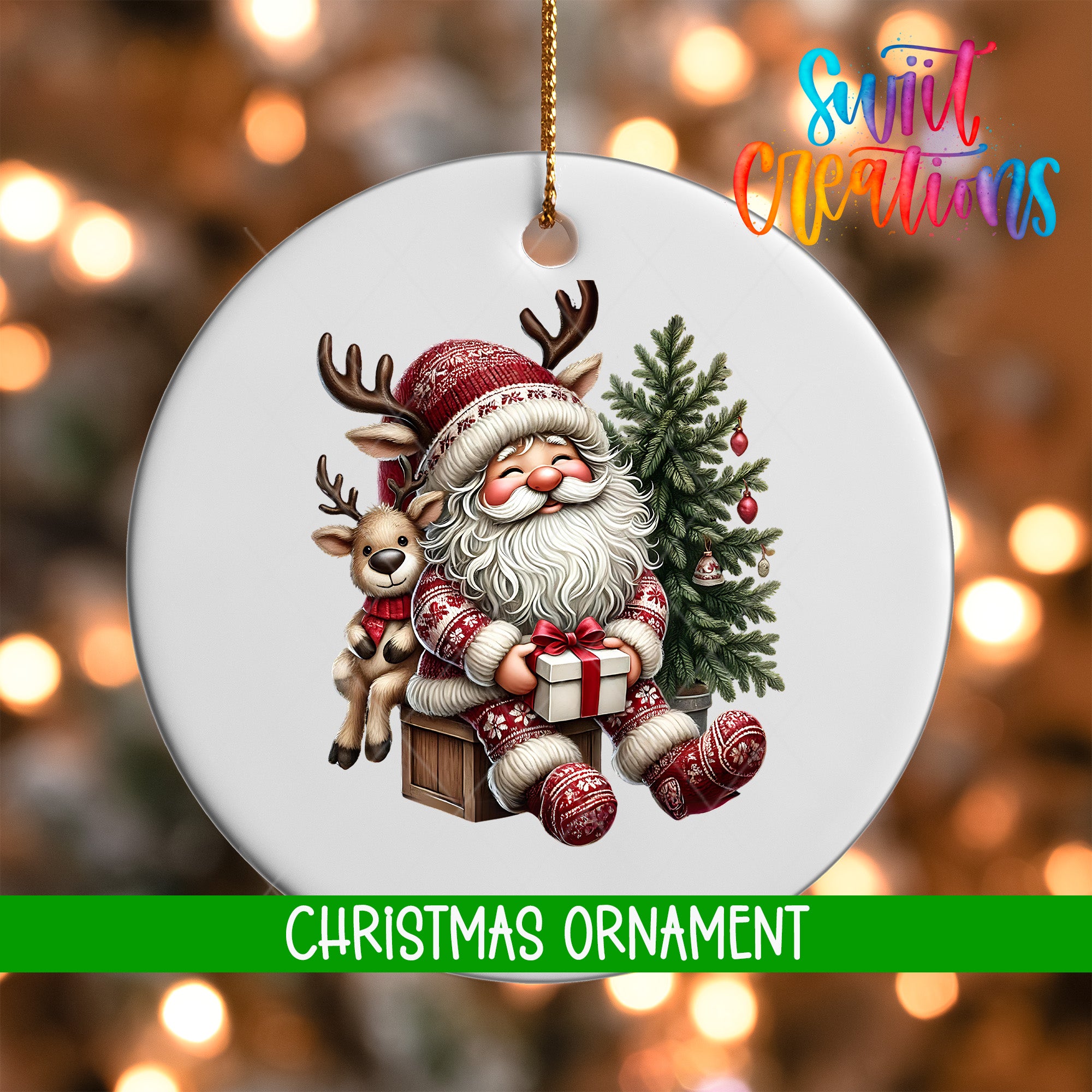 A white Christmas ornament featuring Santa Claus and a reindeer, with a tree and presents, against a blurred background of Christmas lights.