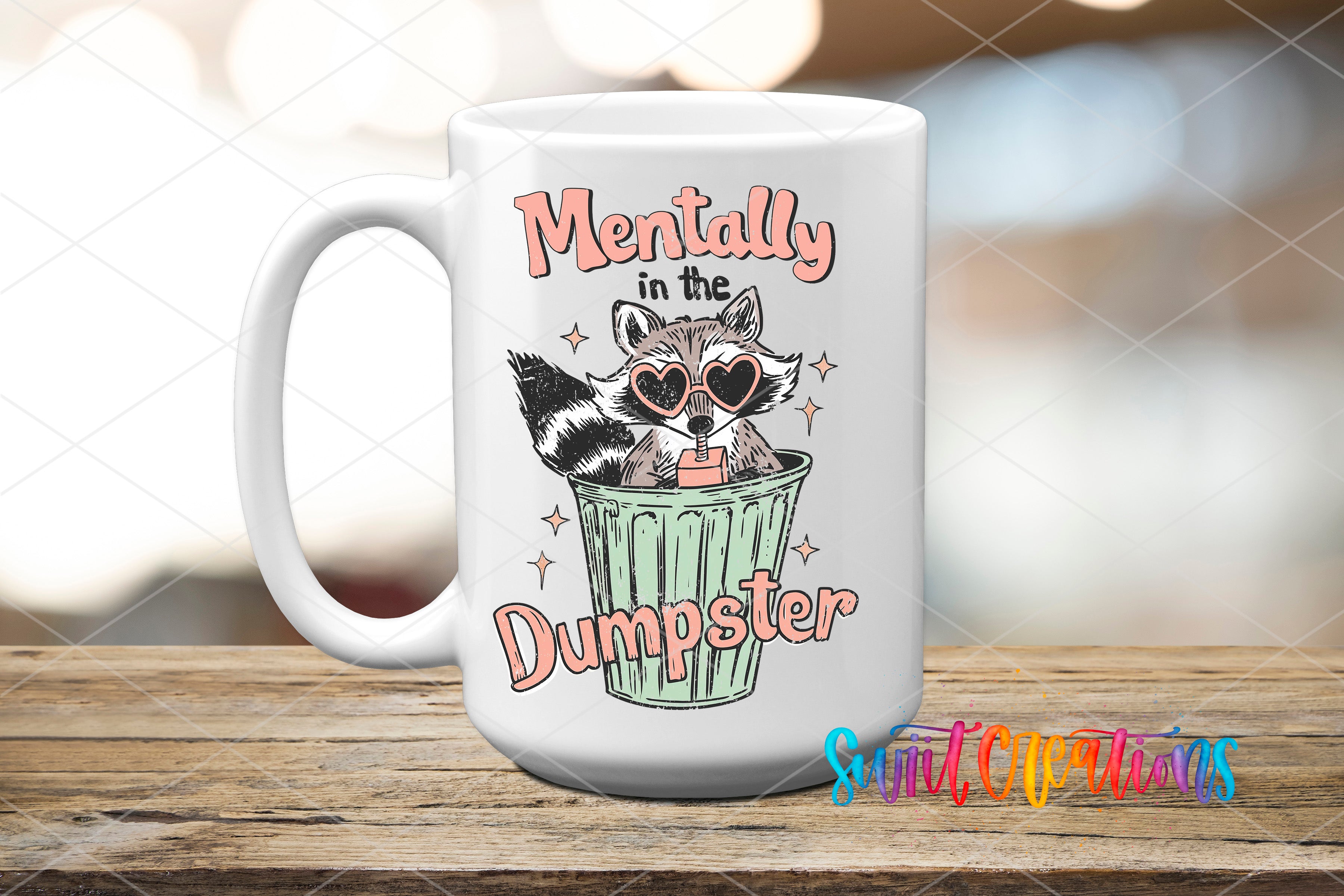A white mug with a graphic design featuring a raccoon wearing sunglasses and the text "Mentally in the Dumpster" printed on it.