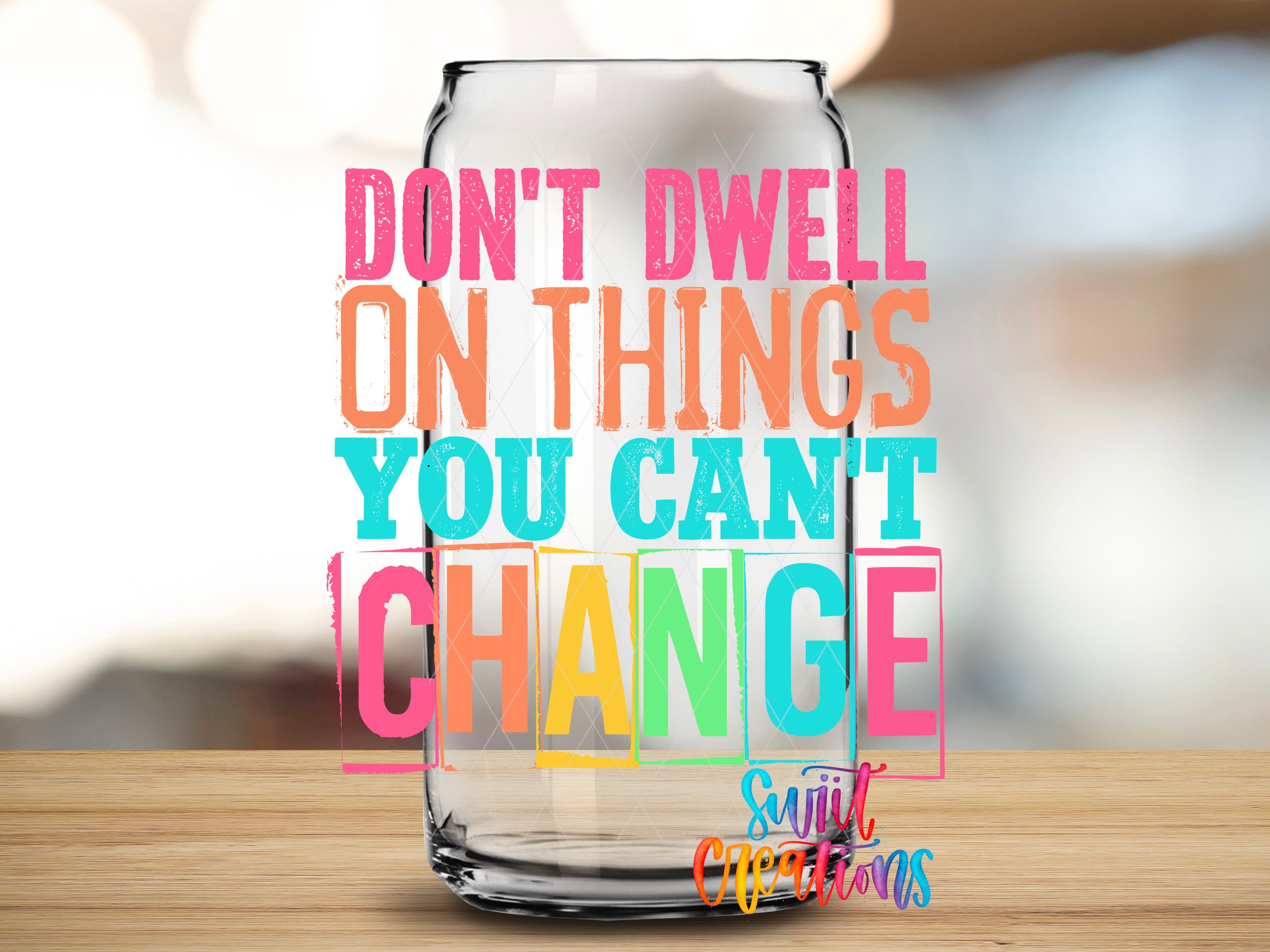 a colorful text overlay on a glass jar, which reads "DON'T DWELL ON THINGS YOU CAN'T CHANGE" in a vibrant, multicolored font.