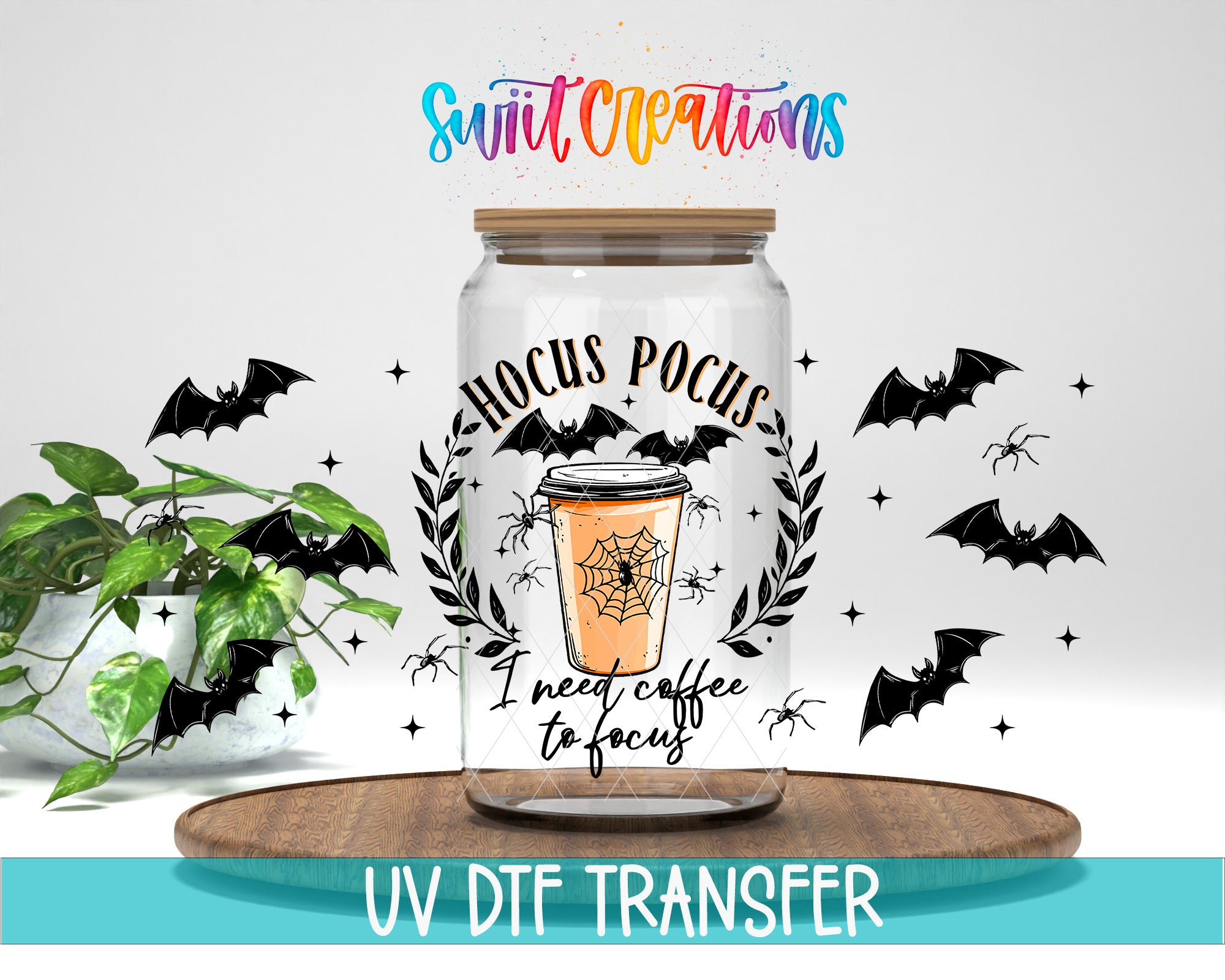 a glass jar with a Halloween-themed design, including bats, a spider, and a coffee cup. The jar is placed on a wooden surface, and there is a plant in the background. The image also includes text that says "Swit Creations" and "I need coffee to focus".