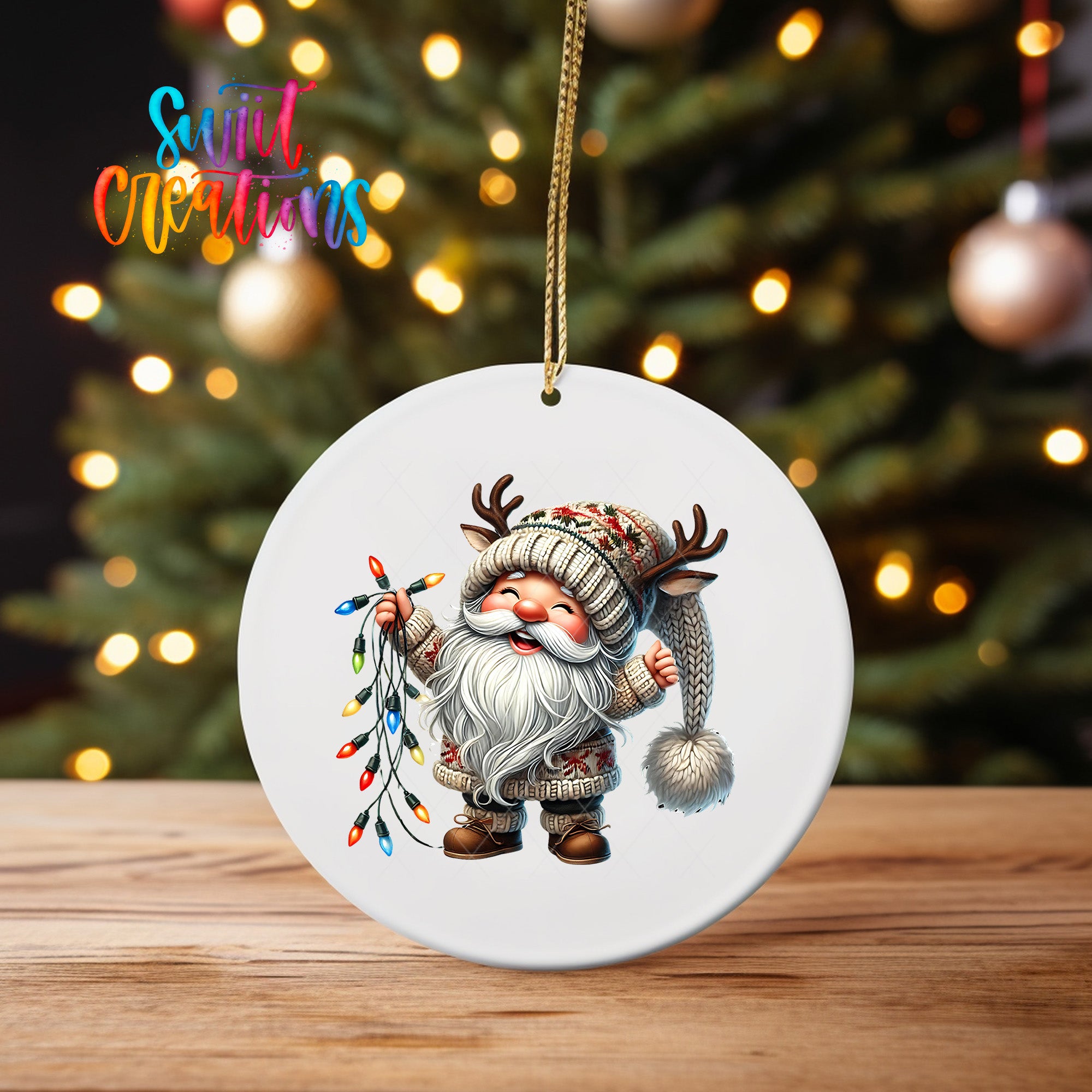 A white ornament featuring a smiling gnome holding a string of colorful Christmas lights, with a blurred background of a decorated Christmas tree.