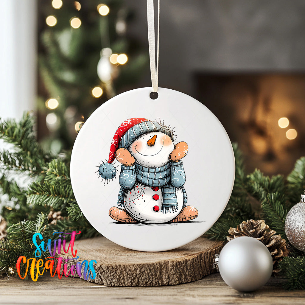 A white ceramic ornament featuring a snowman with a scarf and hat, sitting on a wooden surface surrounded by Christmas decorations.