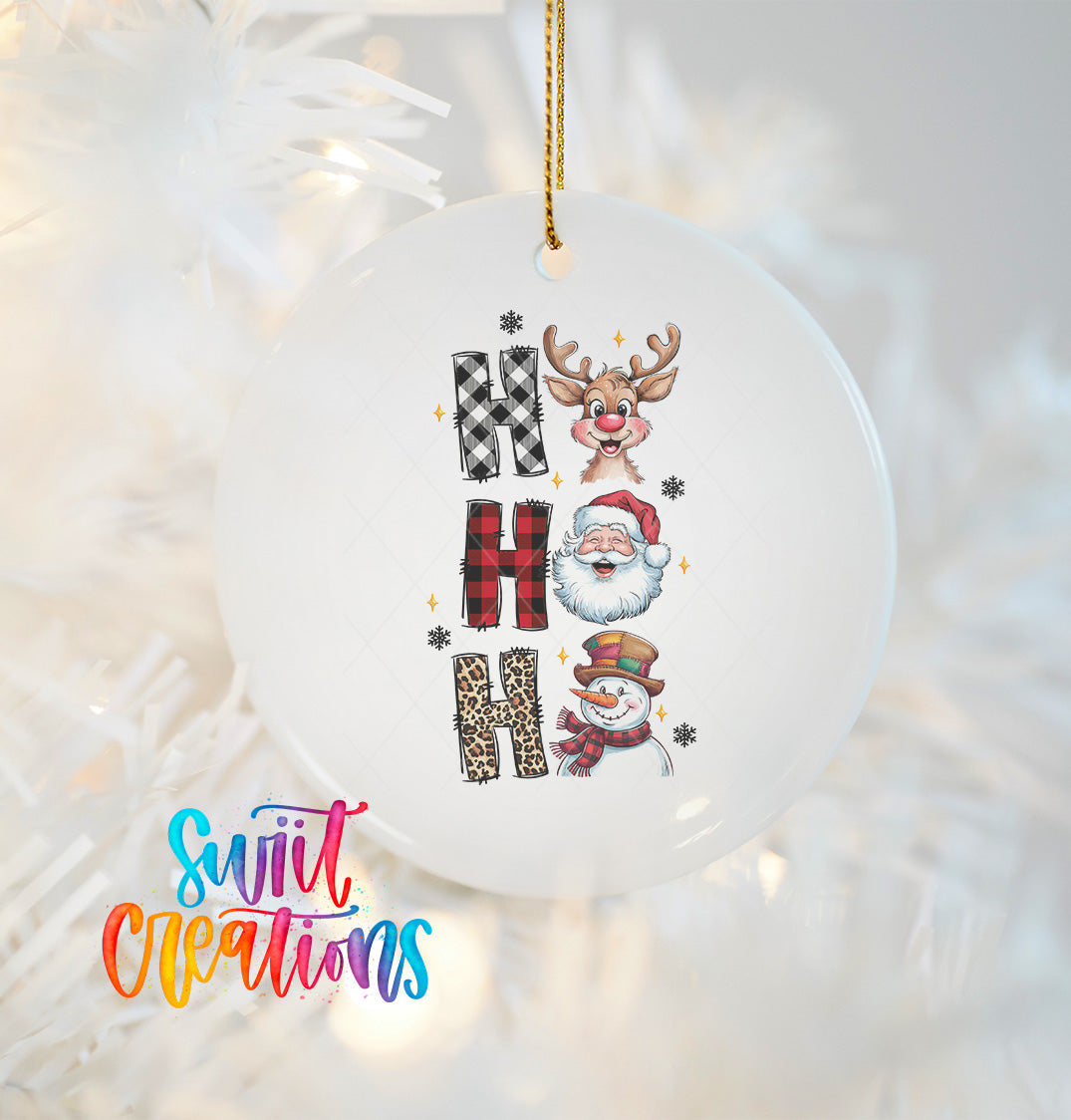 A white ornament with the word "HAPPY" spelled out in a decorative font, featuring a Santa Claus, a reindeer, and a snowman.