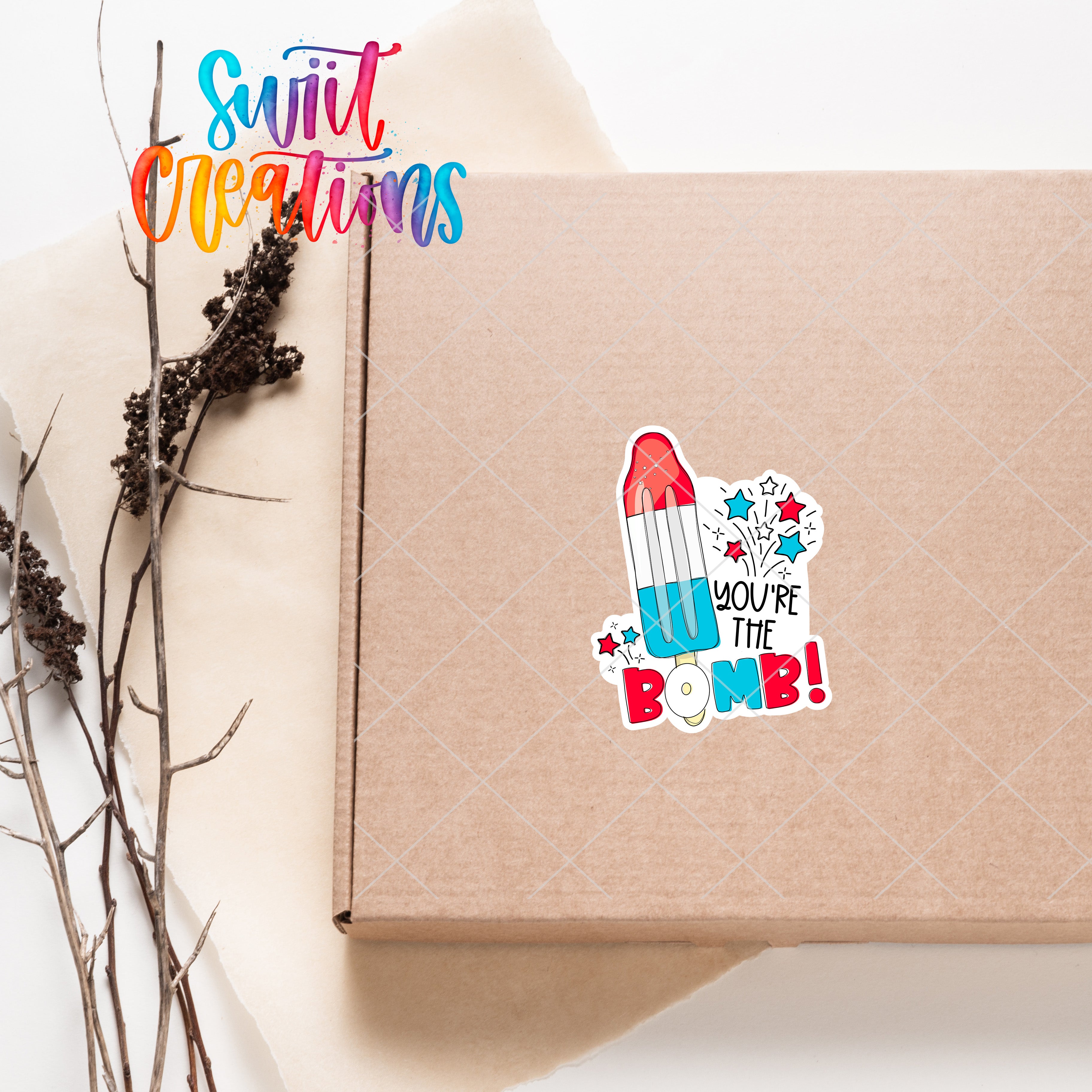 a box with a sticker on it next to a plant